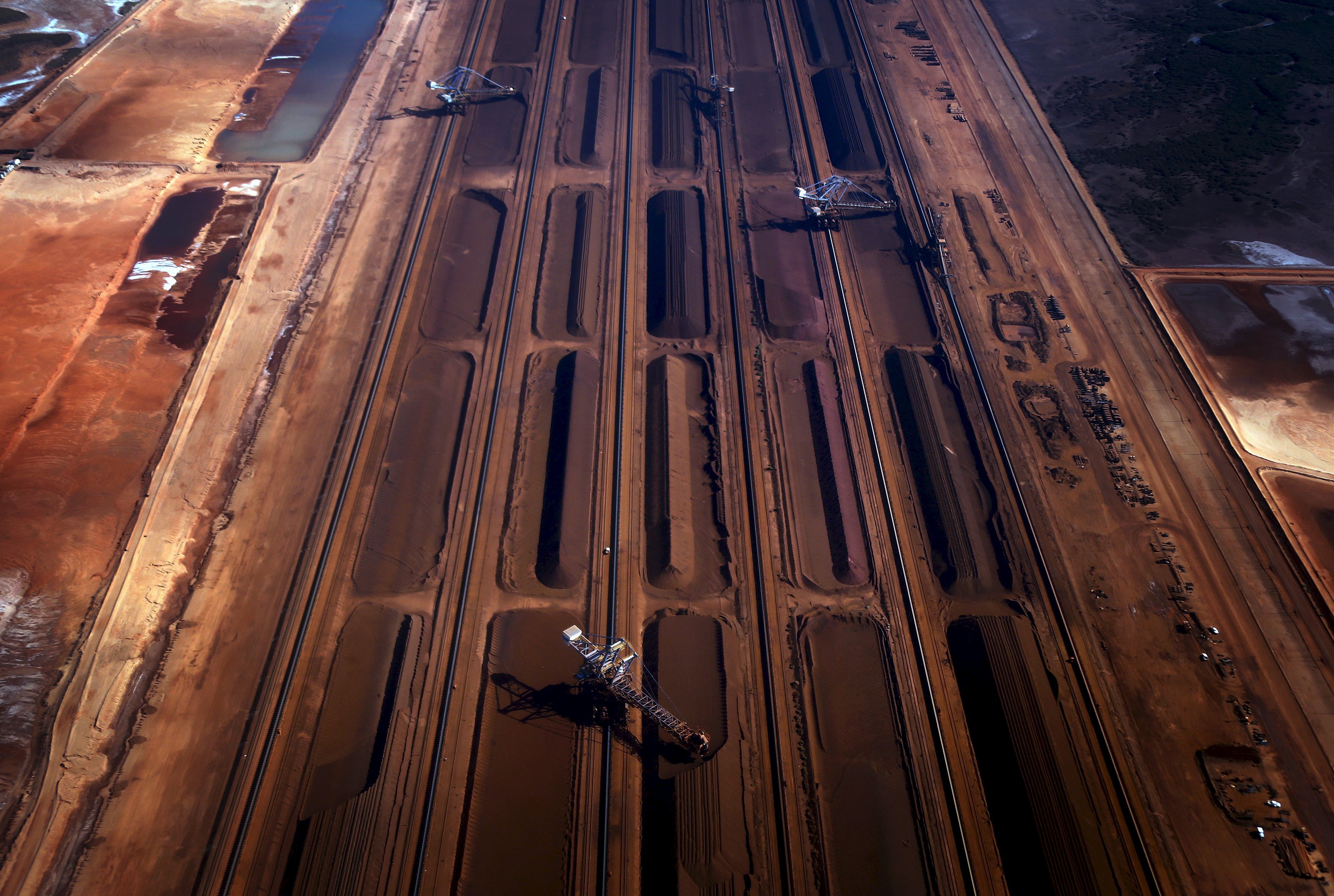 Bucket-wheel reclaimers move iron ore at a loading terminal in the town of Port Hedland, located in the Pilbara region of Western Australia in this December 3, 2013 file photo. Australia is expected to release GDP data this week. REUTERS/David Gray/Files GLOBAL BUSINESS WEEK AHEAD PACKAGE - SEARCH 'BUSINESS WEEK AHEAD NOVEMBER 30' FOR ALL IMAGES