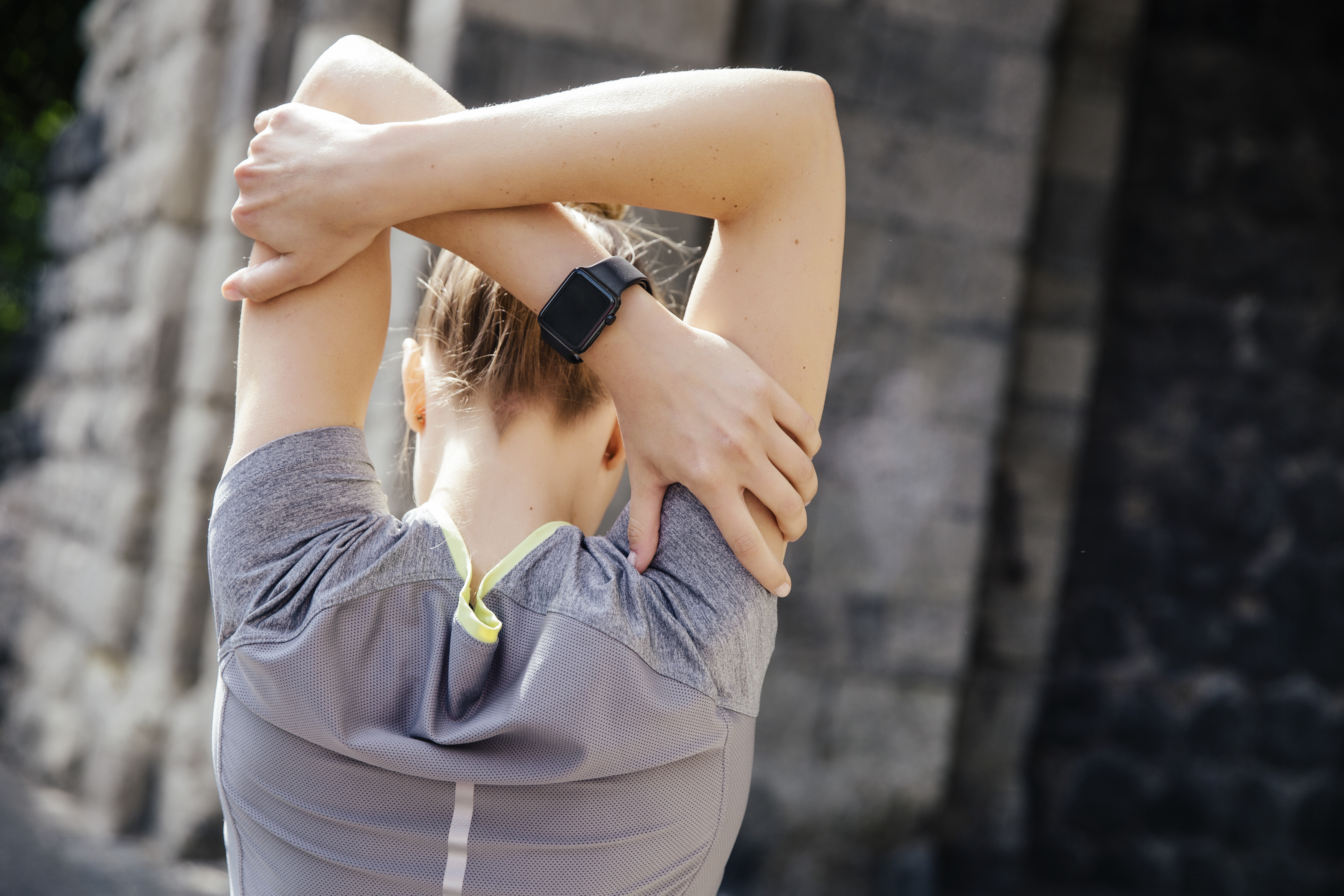 Young sporty woman with smart watch stretching. Photo by Westend61 / Mareen Fischinger / Corbis [08DECEMBER2015 FEATURES FITNESS & WELLBEING]