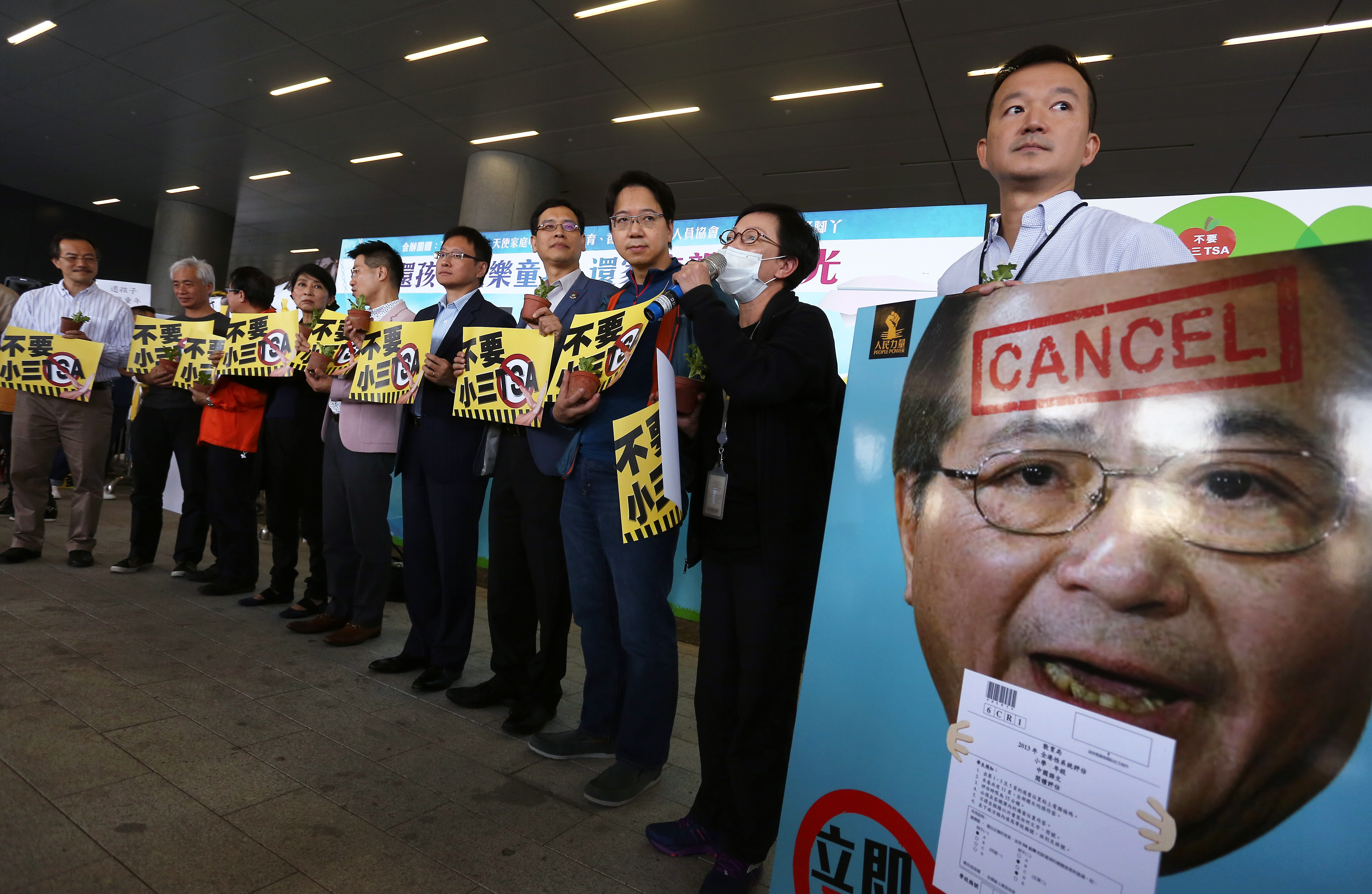 Lawmakers hold placard protest against Territory-wide System Assessment (TSA) Outside Legco Building in Tamar. 29NOV15