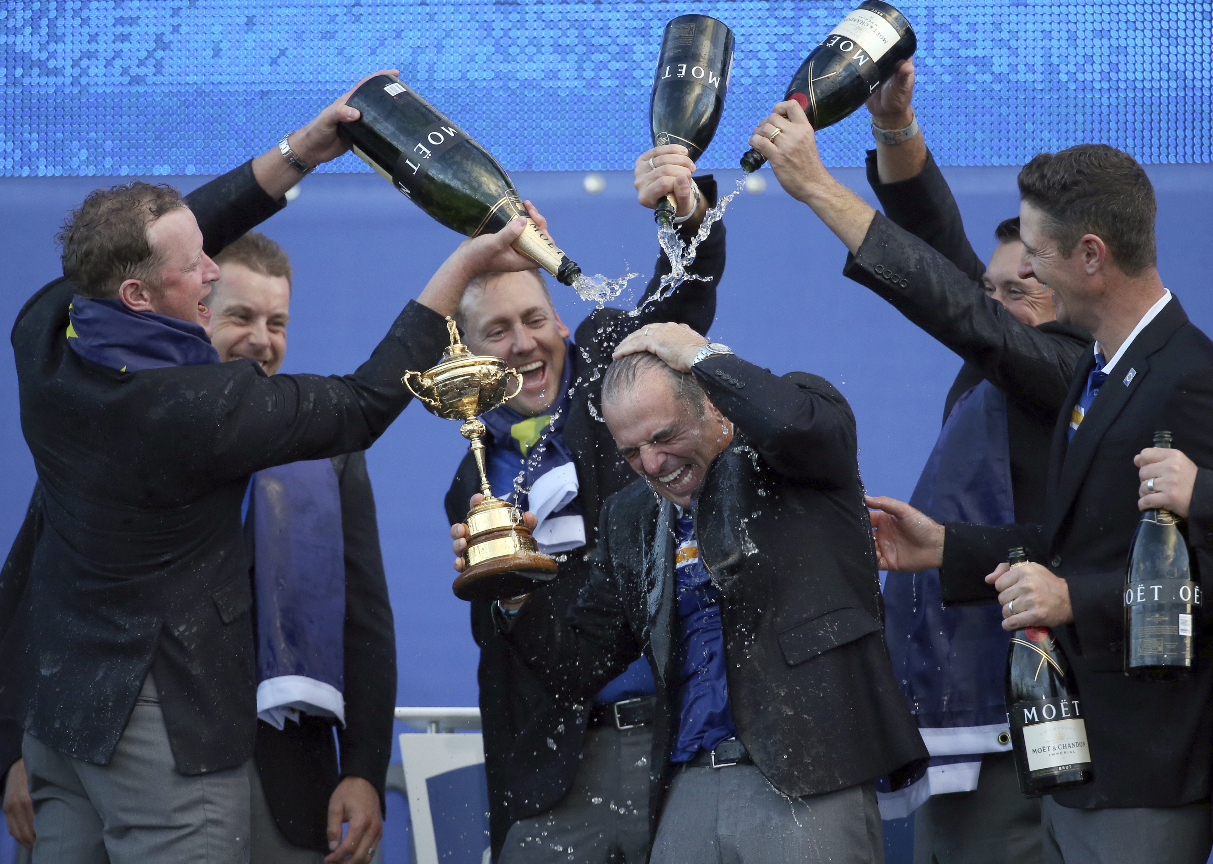 FILE - In this Sunday, Sept. 28, 2014 file photo, from left, Europe's players Jamie Donaldson, Henrik Stenson, Ian Poulter, Lee Westwood and Justin Rose pour champagne over captain Paul McGinley as they celebrate winning the 2014 Ryder Cup golf tournament, at Gleneagles, Scotland. Europe didn’t need to come from behind as it did in Medinah, Illinois, USA, two years ago to win its third Ryder Cup in a row. Soon after US golfer Phil Mickelson criticized his captain Tom Watson. (AP Photo/Scott Heppell, FIle)