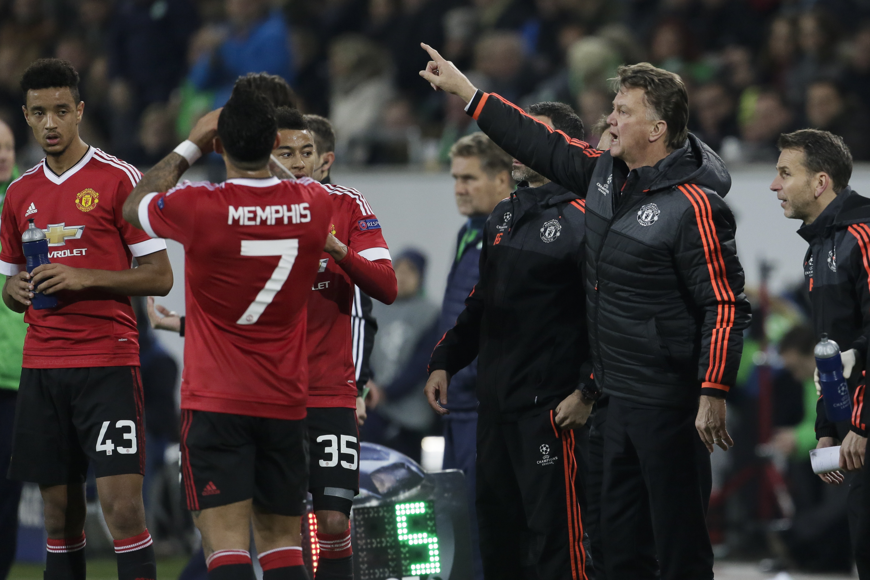Manchester United's manager Louis van Gaal, 2nd from right, gestures to players during the Champions League group B soccer match between VfL Wolfsburg and Manchester United in Wolfsburg, Germany, Tuesday, Dec. 8, 2015. (AP Photo/Markus Schreiber)