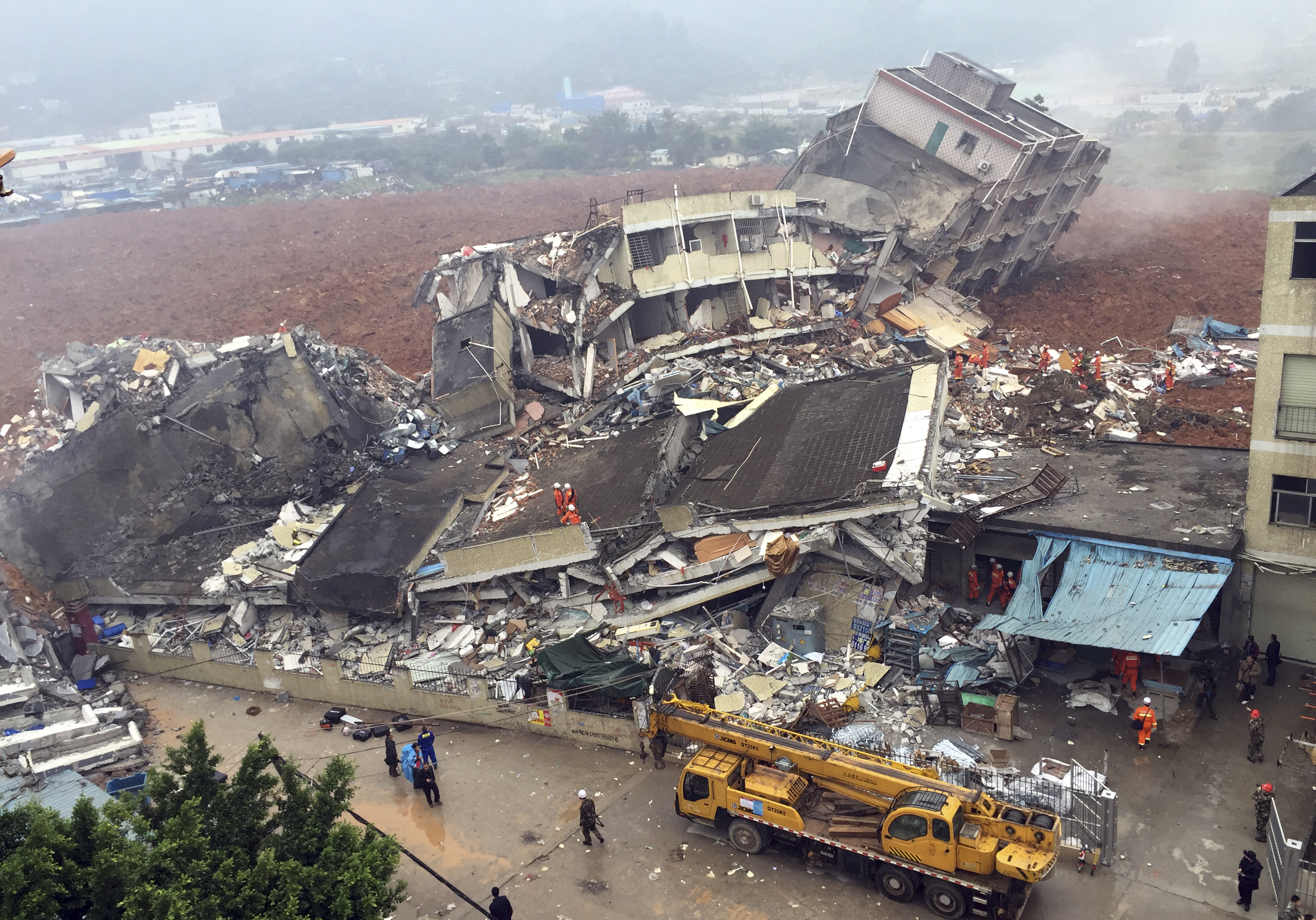 Rescuers search for survivors in the collapsed buildings after a landslide in Shenzhen in south China's Guangdong province on Sunday. The landslide collapsed and buried buildings around an industrial park in the southern Chinese city. Photo: AP