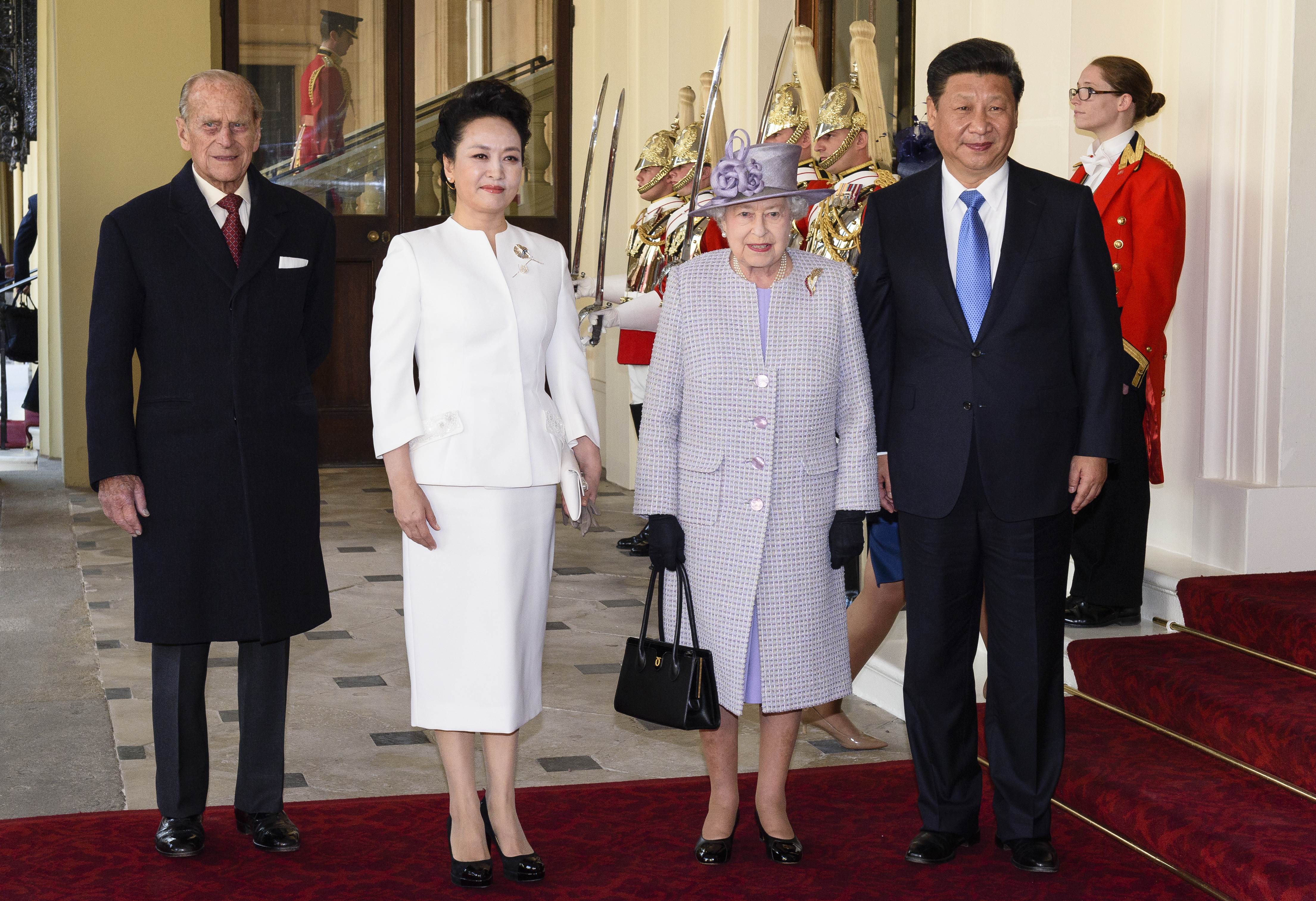 (L-R) Britain's Prince Philip, Duke of Edinburgh, China's First Lady Peng Liyuan, Britain's Queen Elizabeth II and China's President Xi Jinping pose for photographers after arriving at Buckingham Palace in central London on October 20, 2015, during the ceremonial welcome on the first official day of the Chinese president's state visit. China's President Xi Jinping started a pomp-filled four-day state visit to Britain as reports emerged of a multibillion pound investment deal over Britain's new nuclear programme. AFP PHOTO / POOL / LEON NEAL