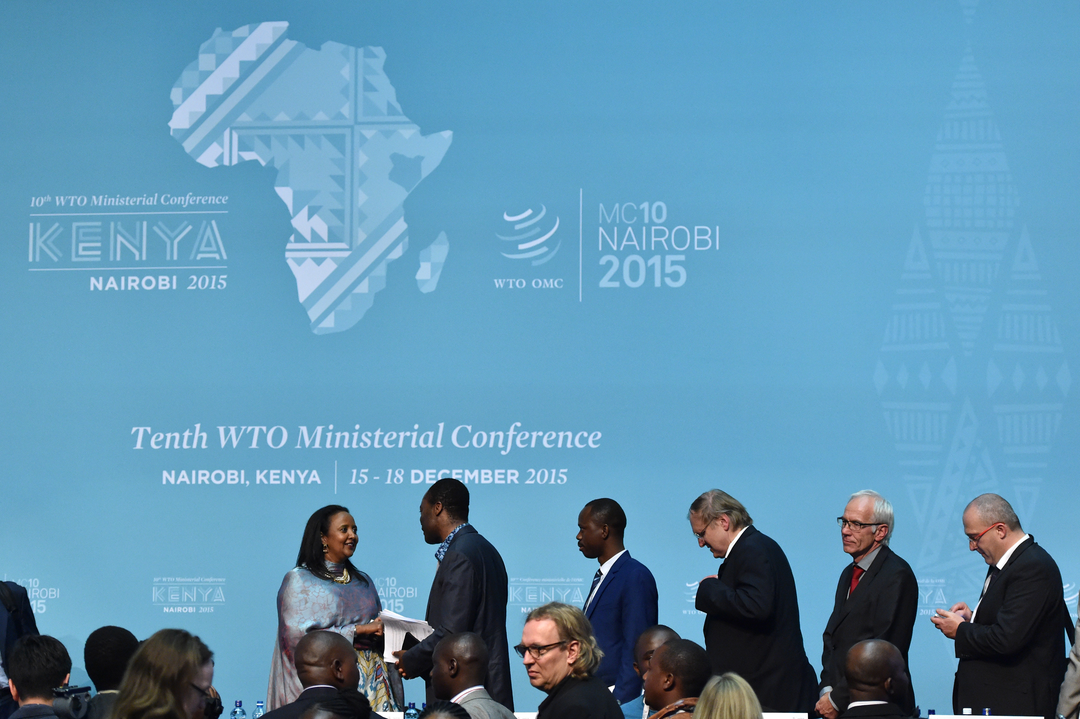 (151219)-- NAIROBI, Dec. 19, 2015(Xinhua)-- Delegates congratulate Chair of the 10th WTO Ministerial Conference and Kenyan Foreign Minister Amina Mohamed (1st L) for the achievements of the conference after the closing of the 10th WTO Ministerial Conference in Nairobi, Kenya, Dec. 19, 2015. The 10th Ministerial Conference of the World Trade Organization (WTO) in Nairobi came to an end on Saturday after an extended negotiating period with a new Nairobi Declaration that promises to keep the international trading system alive.(Xinhua/Sun Ruibo)