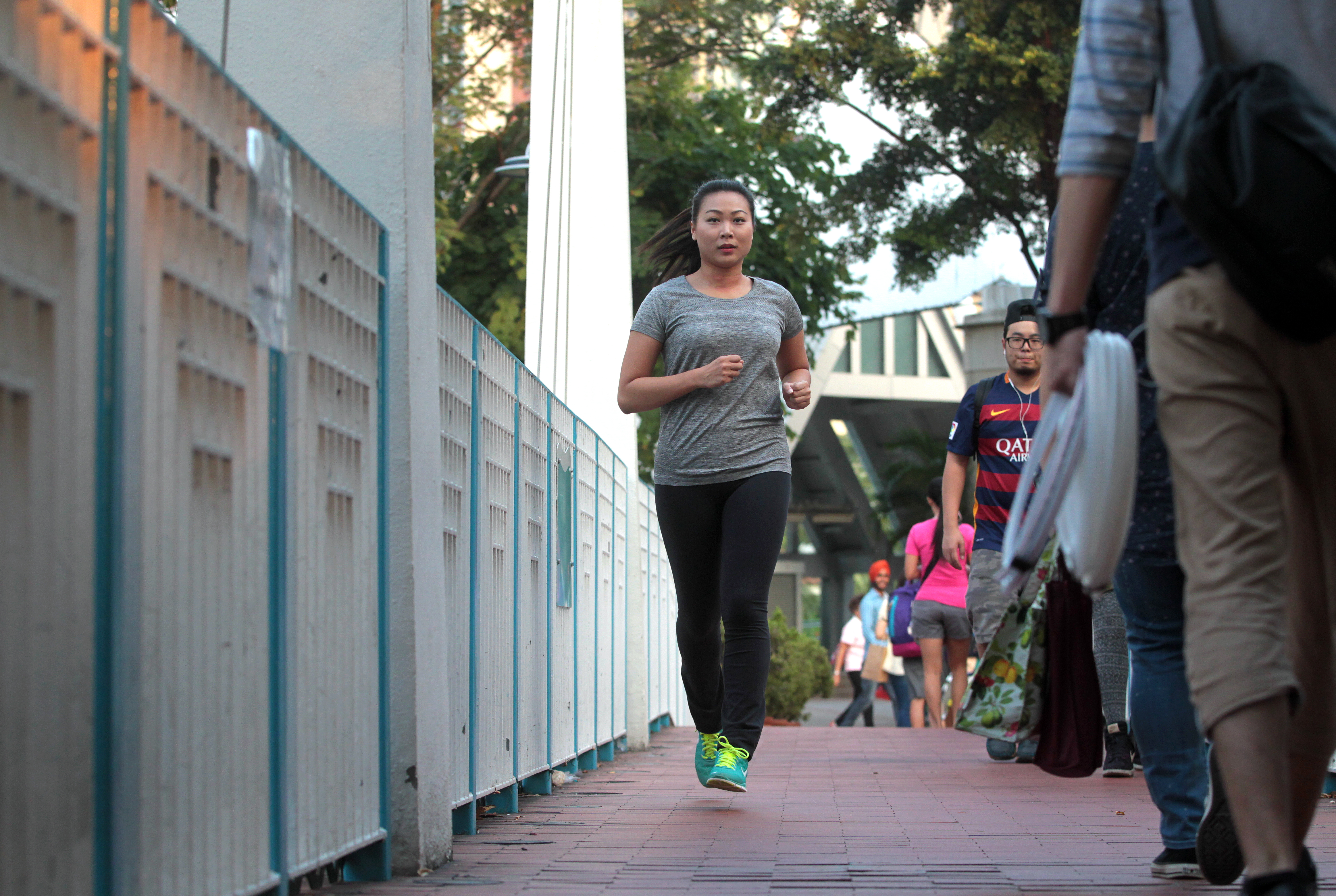 This image shows Vivian Siu Yun-ki, running in Tsuen Wan Park. To illustrate story on insurance packages to push people to exercise. 24NOV15 [2015 FEATURES]