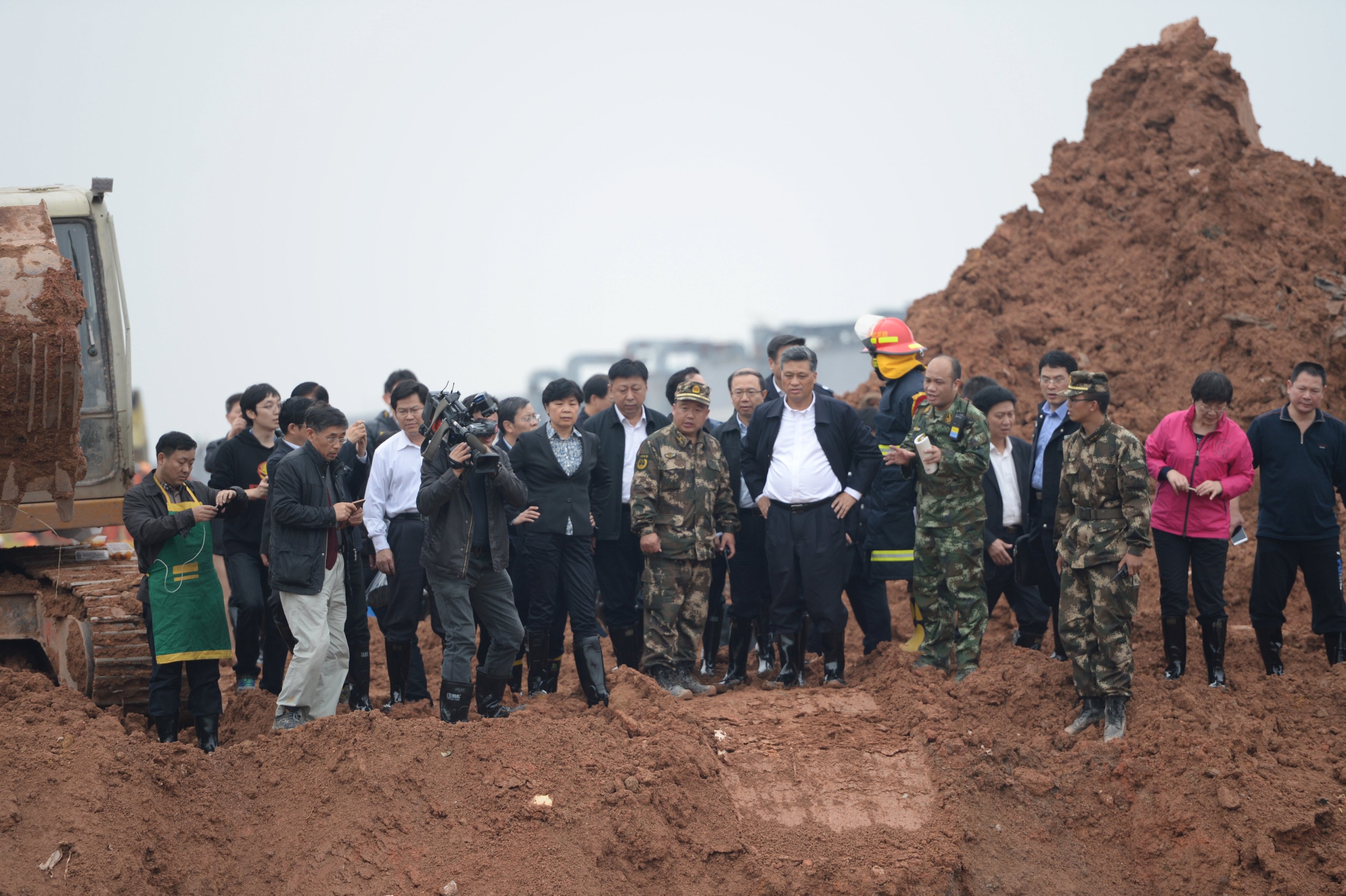 Ma Xingrui (front, 3rd R), municipal party secretary of Shenzhen, and other officials visit the site after a landslide hit an industrial park in Shenzhen, Guangdong province, December 21, 2015. REUTERS/Stringer ATTENTION EDITORS - THIS PICTURE WAS PROVIDED BY A THIRD PARTY. THIS PICTURE IS DISTRIBUTED EXACTLY AS RECEIVED BY REUTERS, AS A SERVICE TO CLIENTS. CHINA OUT. NO COMMERCIAL OR EDITORIAL SALES IN CHINA.