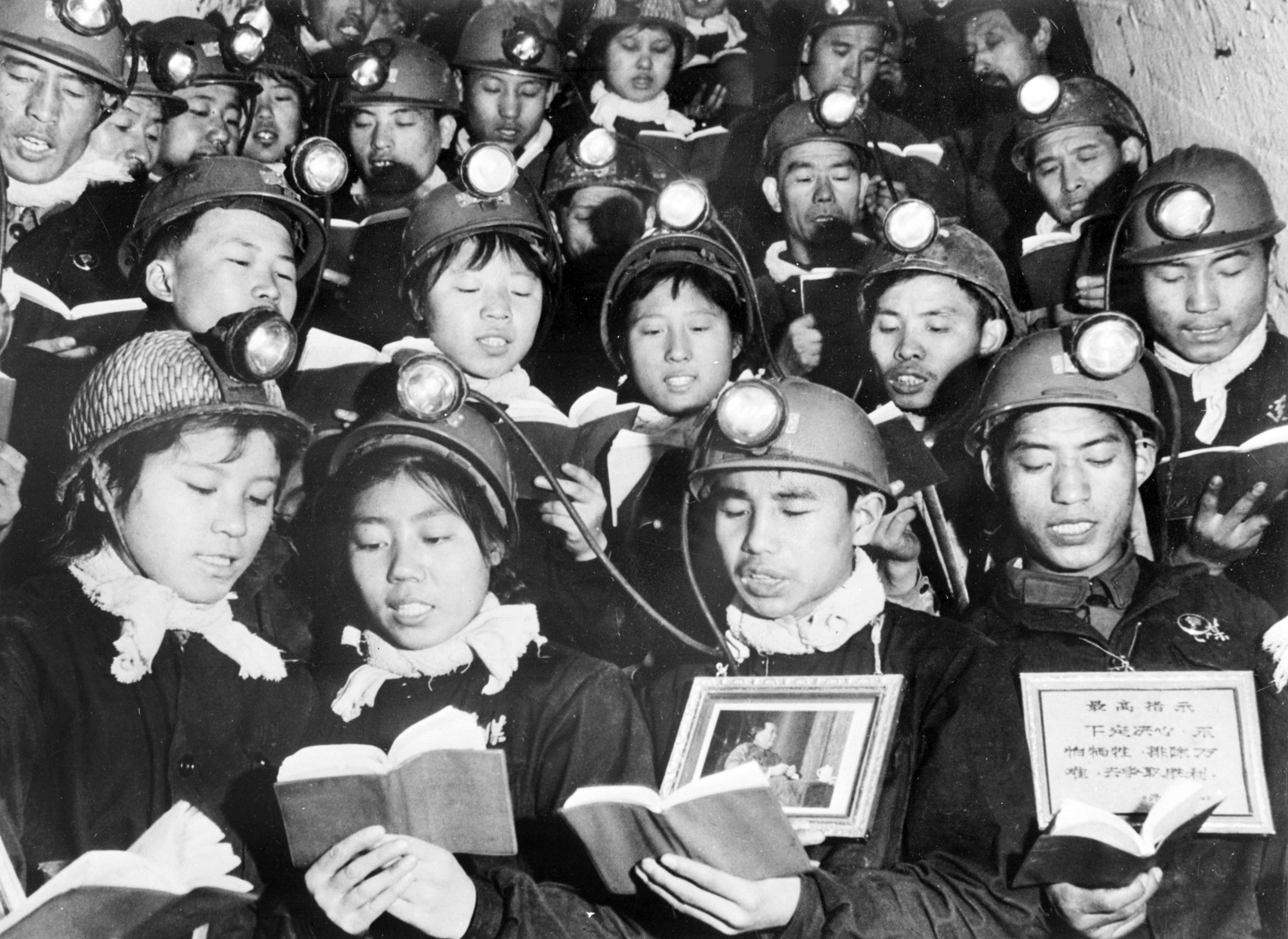 TO GO WITH VARIOUS AFP STORIES "China-politics-history" (FILES) This file photo dated 06 September, 1968 shows a group of male and female coal miners reciting in Li Se Yuan mine some paragraphs of Mao Zedong "Little Red Book" as they celebrate Mao's "Great Proletarian Cultural Revolution". May 16, 2006 marks the 40th anniversary of the official launch of the Great Proletarian Cultural Revolution when Mao Zedong issued a directive charging that "representatives of the bourgeoisie" have infiltrated all levels of the party and intend to establish a "dictatorship". Subsequently millions of people across China were tortured, killed and driven to suicide during the Cultural Revolution (1966-1976), a period of terror and violence now widely known as "10 years of catastrophe". AFP PHOTO/XINHUA/FILES
