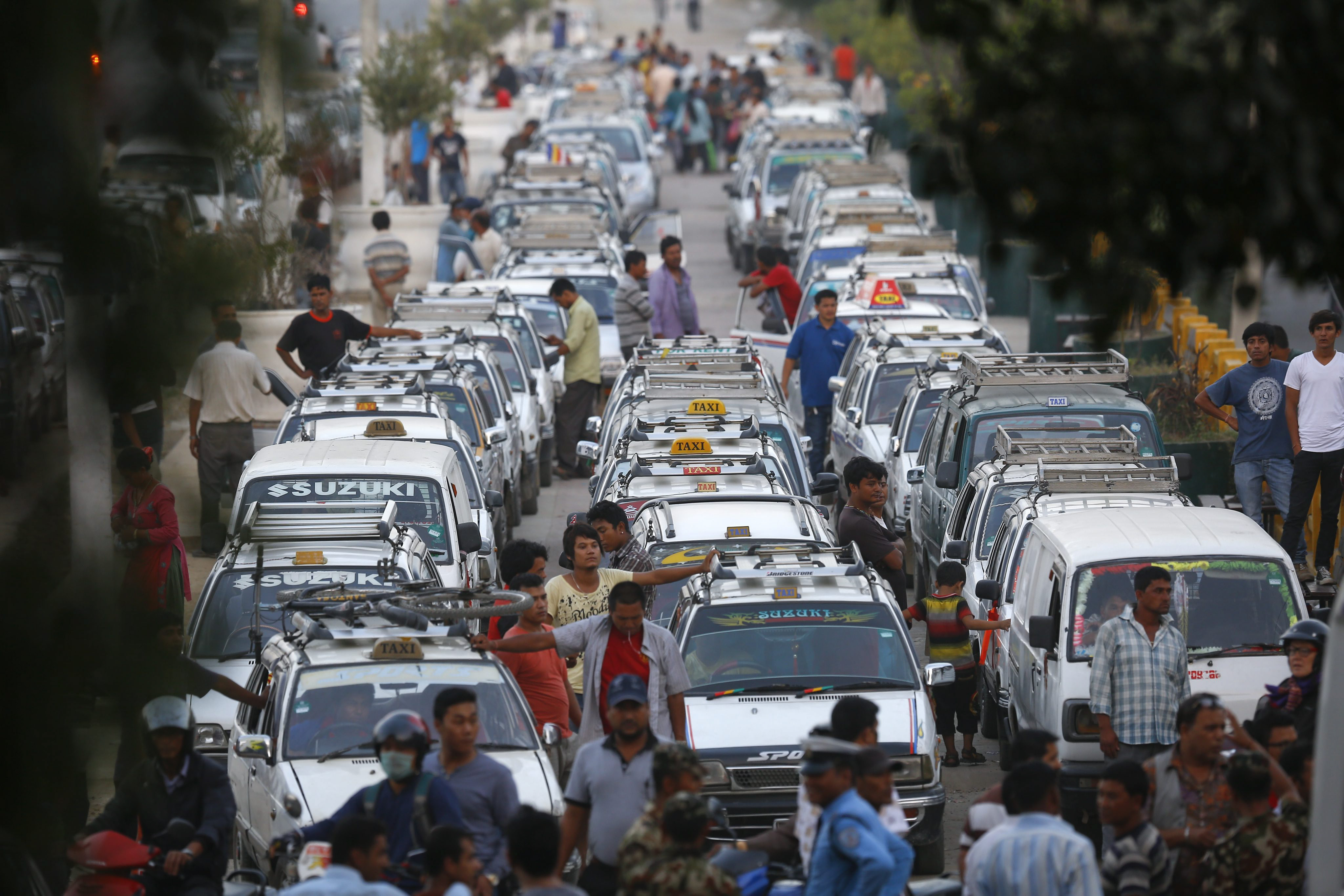 epa04958716 A line of taxis as drivers wait for fuel at a petrol station in Kathmandu, Nepal, 01 October 2015. The Nepalese are facing an acute crisis of petroleum products and other essential commodities after neighboring India stopped supplies. The Nepalese government has stopped providing fuel to private number plate vehicles across the country due to the fuel shortage. Nepal, a small landlocked country, depends on supplies from India. EPA/NARENDRA SHRESTHA