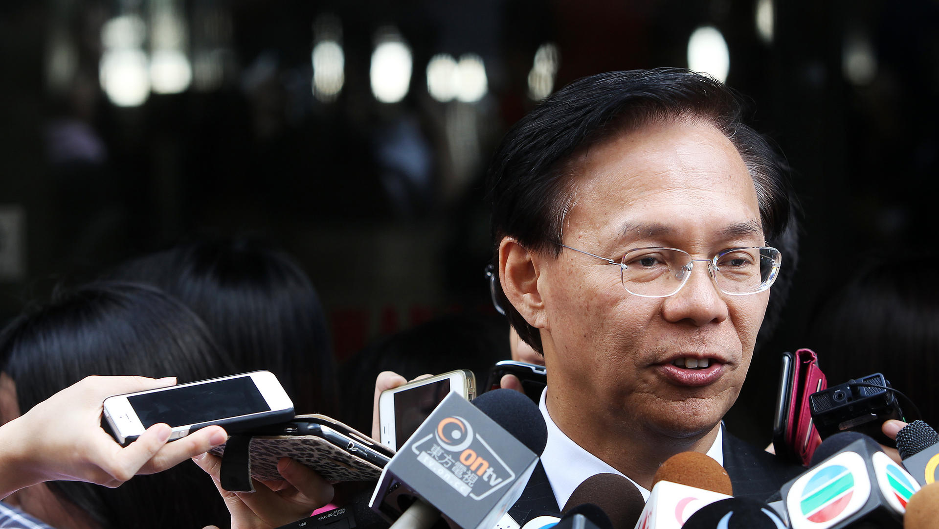 Former development secretary Mak Chai-kwong leaves District Court in Wan Chai after sentence for cheating on government housing allowances in the 1980s. 08AUG13