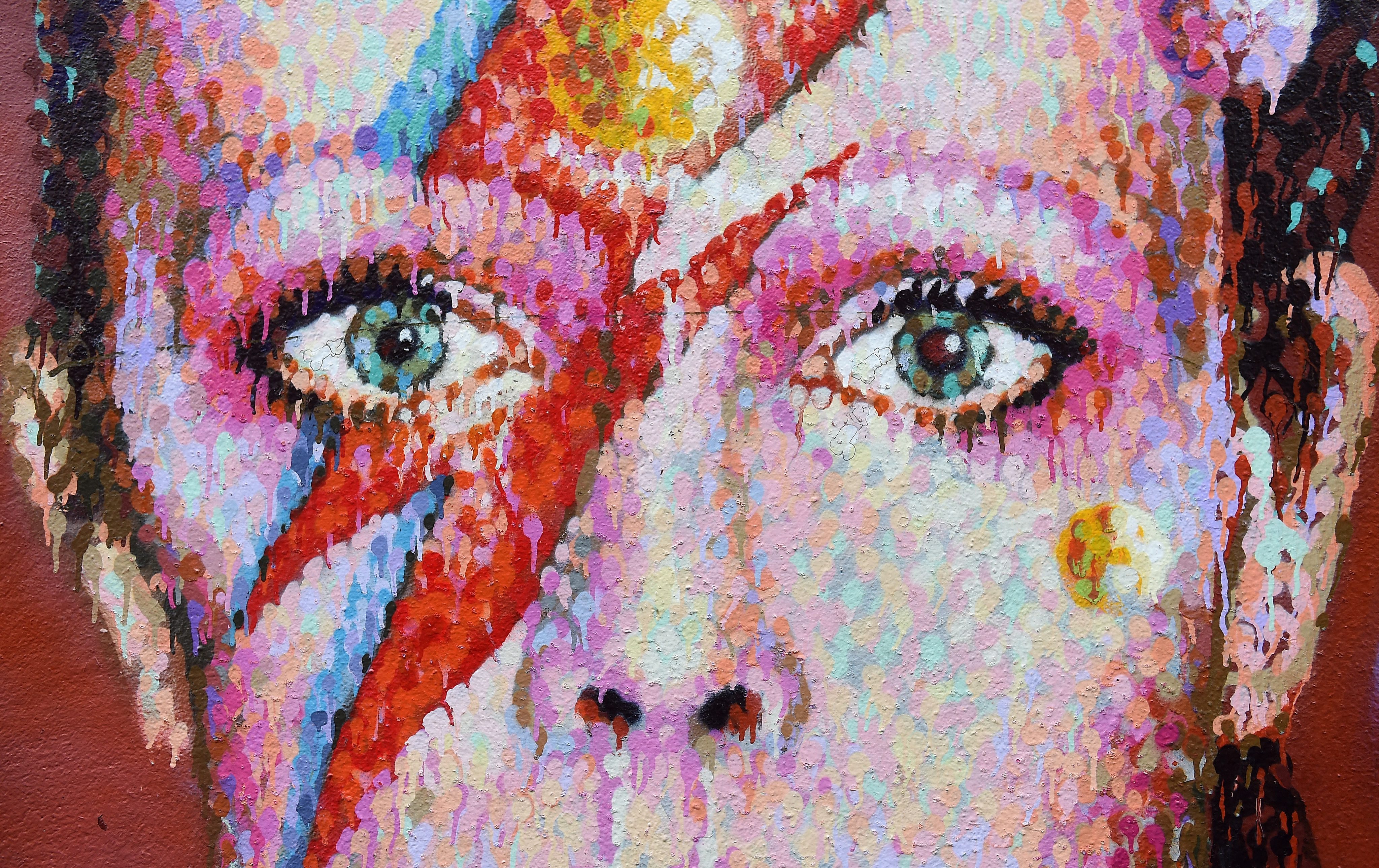 epa05096807 A mural of British singer David Bowie in Brixton, birth place of the late David Bowie in London, Britain, 11 January 2016. Well-wishers have flocked to the Bowie mural to pay their respects following the announcement of his death. According to reports quoting David Bowie's son and his official Facebook page, Bowie, 69, has died on 10 January 2016 after a battle with cancer. EPA/ANDY RAIN