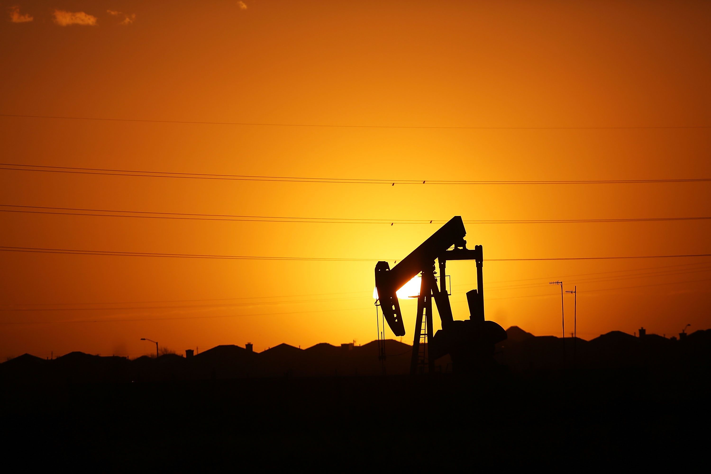 MIDLAND, TX - JANUARY 20: A pumpjack sits on the outskirts of town at dawn in the Permian Basin oil field on January 21, 2016 in the oil town of Midland, Texas. Despite recent drops in the price of oil, many residents of Andrews, and similar towns across the Permian, are trying to take the long view and stay optimistic. The Dow Jones industrial average plunged 540 points on Wednesday after crude oil plummeted another 7% and crashed below $27 a barrel. Spencer Platt/Getty Images/AFP == FOR NEWSPAPERS, INTERNET, TELCOS & TELEVISION USE ONLY ==