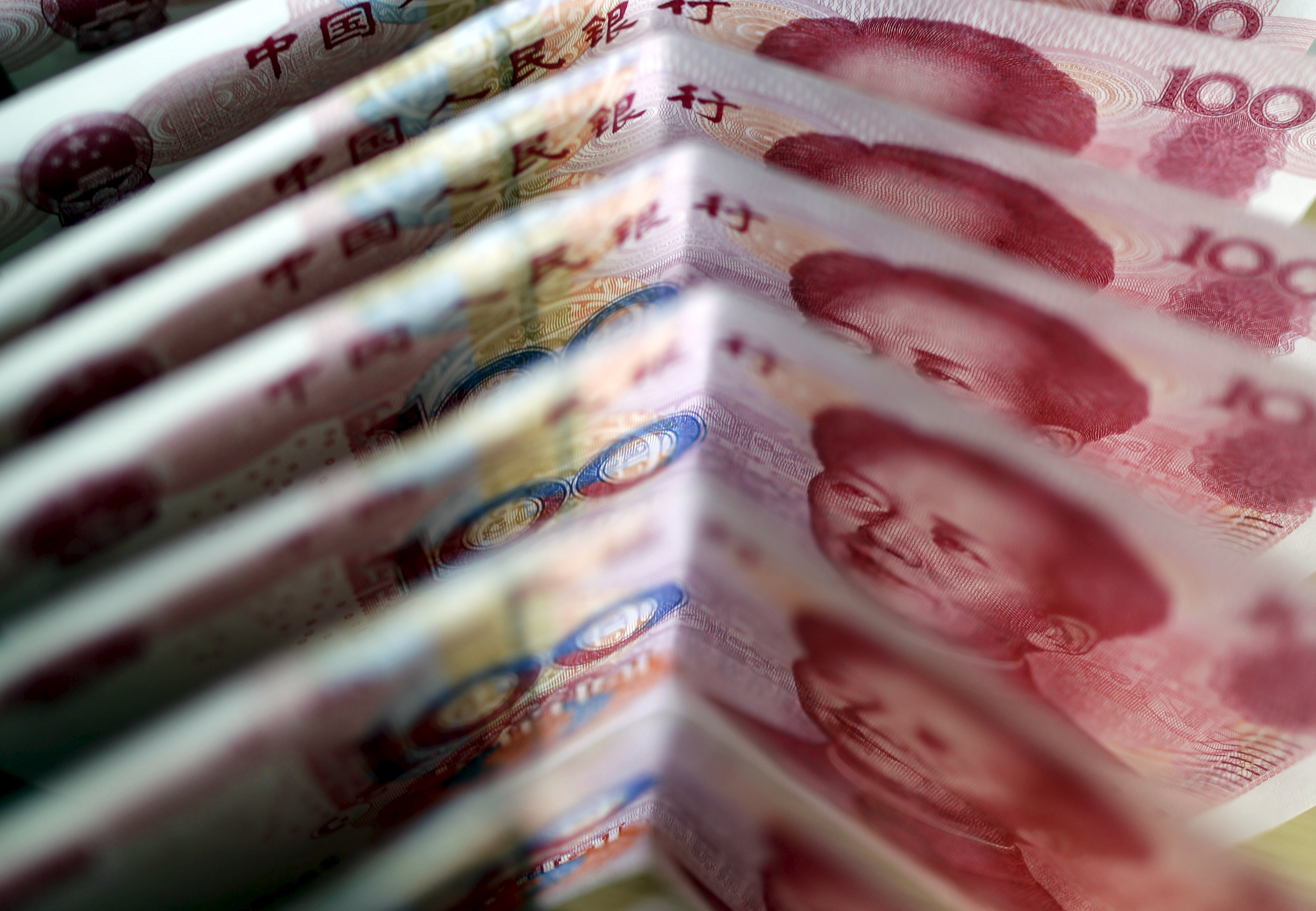 One-hundred Yuan notes are seen in this file picture illustration in Beijing in this March 22, 2011 file photo. China's yuan firmed in early trade on Friday after the central bank strengthened its official rate for the first time in nine trading days.REUTERS/Jason Lee/Files
