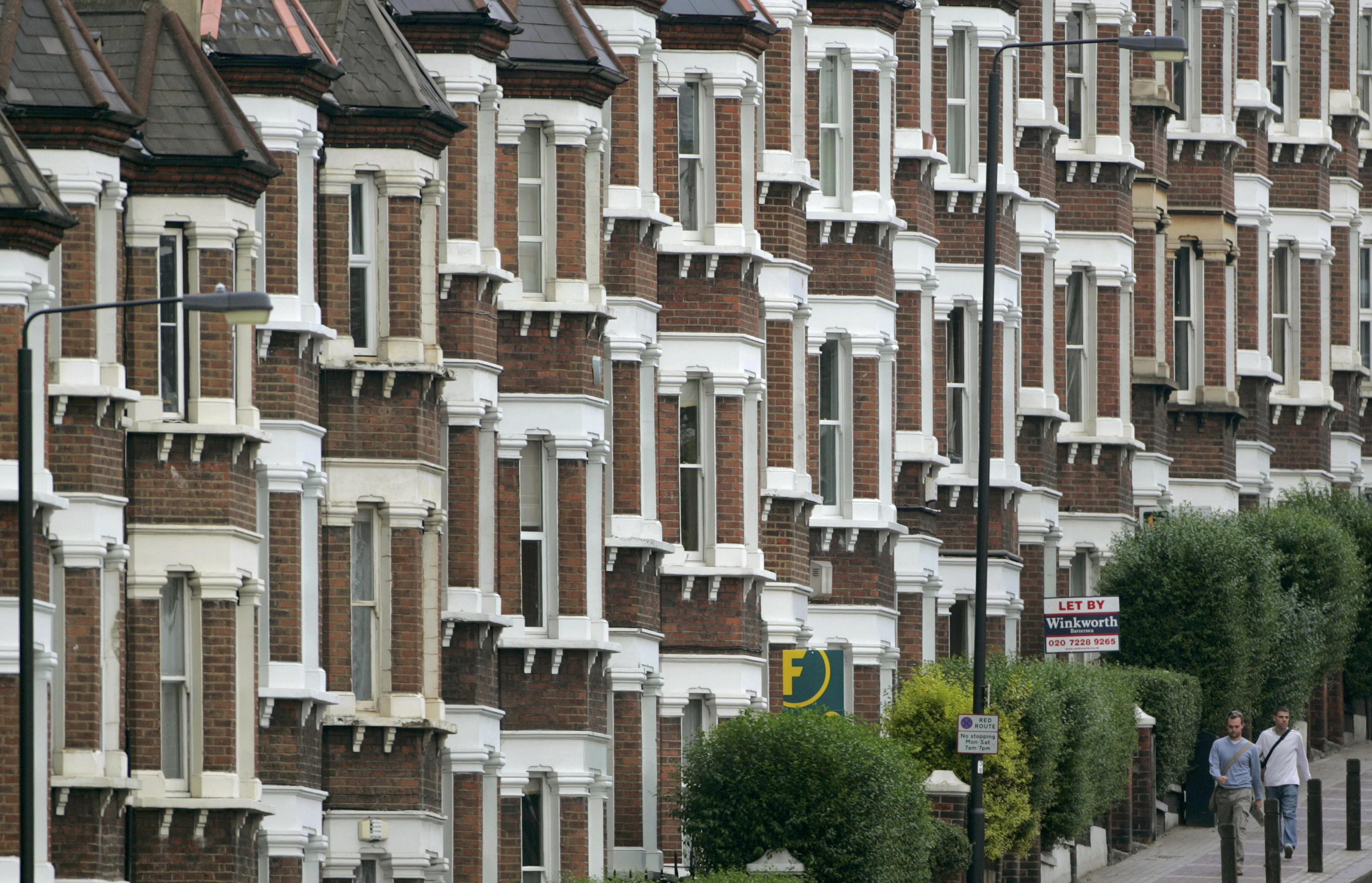 People are seen walking past estate agent signs outside a row of houses in south London, in this file photograph dated May 18, 2007. They have pocketed some of the most lucrative returns available to investors in recent decades and been a staple of newspapers' personal finance pages, but tougher times now lie ahead for Britain's army of small-time landlords. REUTERS/Toby Melville/Files