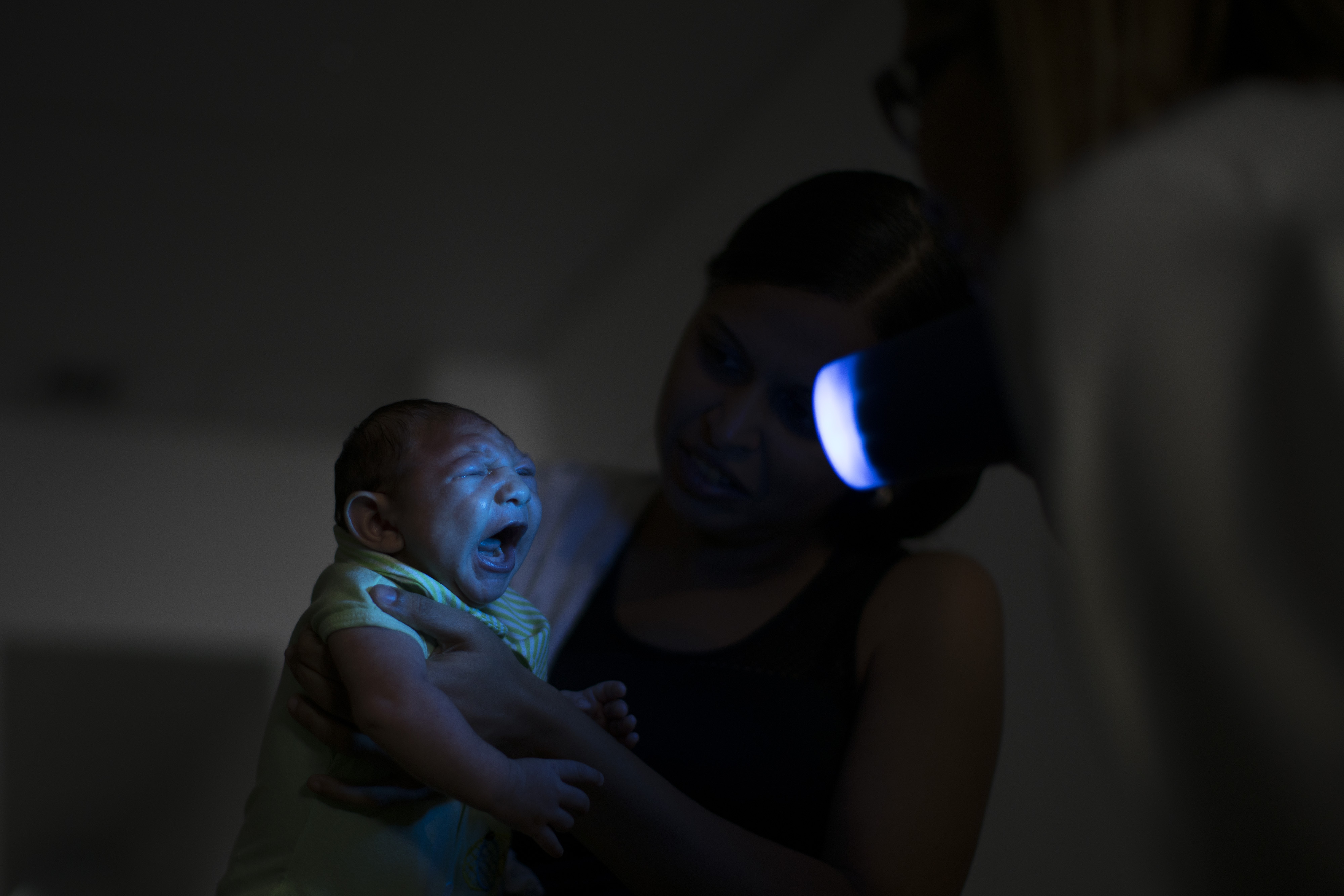In this Thursday, Jan. 28, 2016 photo, Daniele Ferreira dos Santos holds her son Juan Pedro as he undergoes visual exams at the Altino Ventura foundation in Recife, Pernambuco state, Brazil. Santos was never diagnosed with Zika, but she blames the virus for her son’s defect and for the terrible toll it has taken on her life. (AP Photo/Felipe Dana)