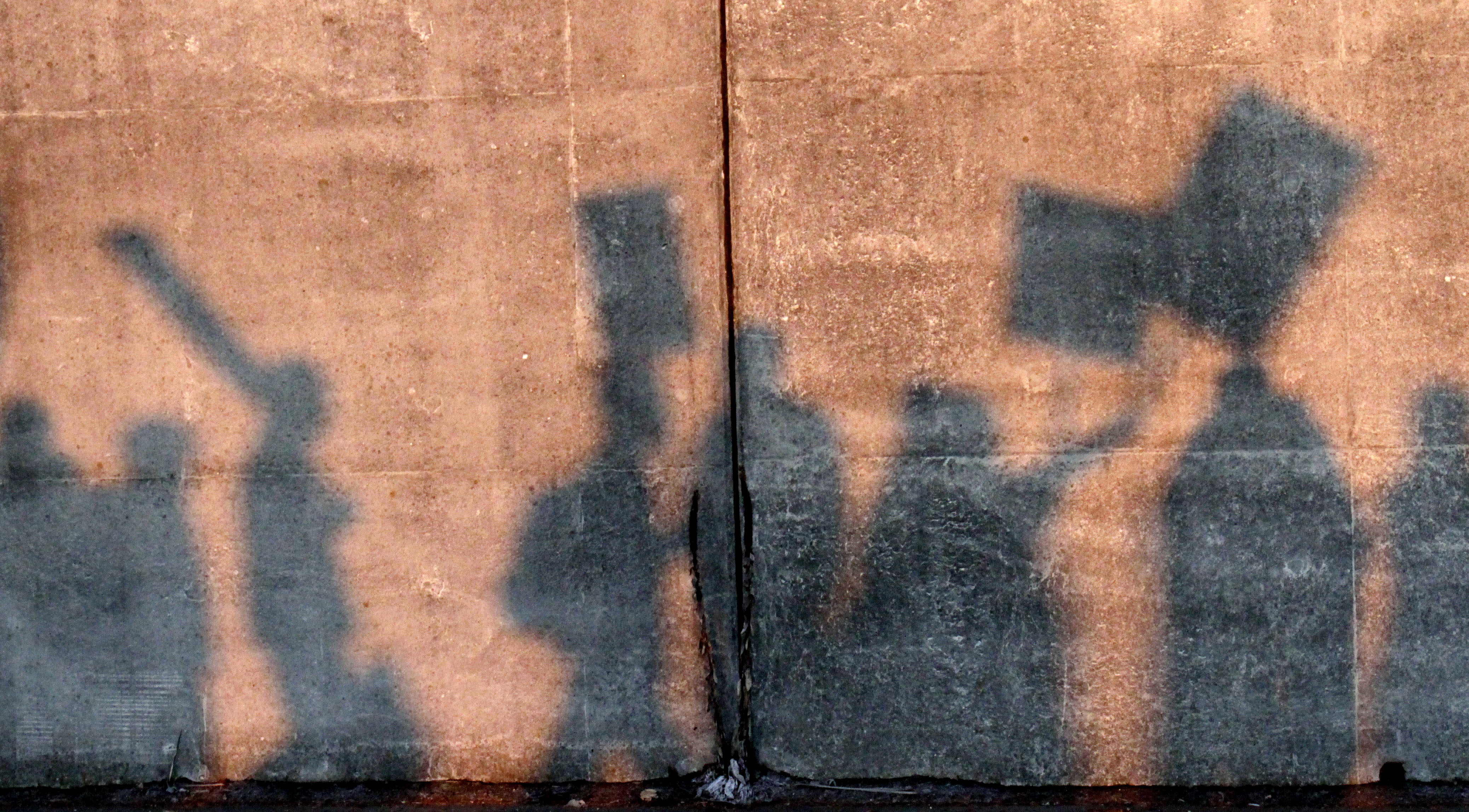 The morning sun casts shadows of protesters as they march in front of an entrance to the Port of Longview in Longview, Wash., Monday, Dec. 12, 2011. Anti-Wall Street protesters along the West Coast joined an effort Monday to blockade some of the nation's busiest docks, with the idea that if they cut off the ports, they cut into corporate profits. (AP Photo/Don Ryan)