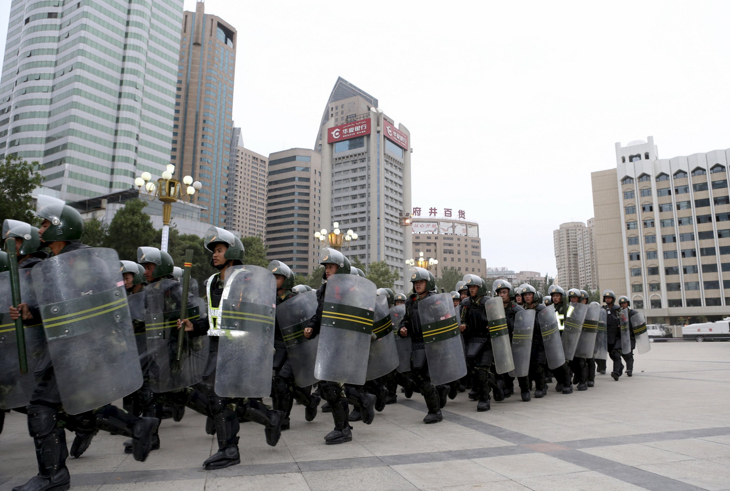 Armed paramilitary policemen run in formation during a gathering to mobilize security operations in Urumqi, Xinjiang Uighur Autonomous Region, in this June 29, 2013 file photo. To match Insight CHINA-XINJIANG/COTTON REUTERS/Stringer/Files ATTENTION EDITORS - THIS PICTURE WAS PROVIDED BY A THIRD PARTY. THIS PICTURE IS DISTRIBUTED EXACTLY AS RECEIVED BY REUTERS, AS A SERVICE TO CLIENTS. CHINA OUT. NO COMMERCIAL OR EDITORIAL SALES IN CHINA.