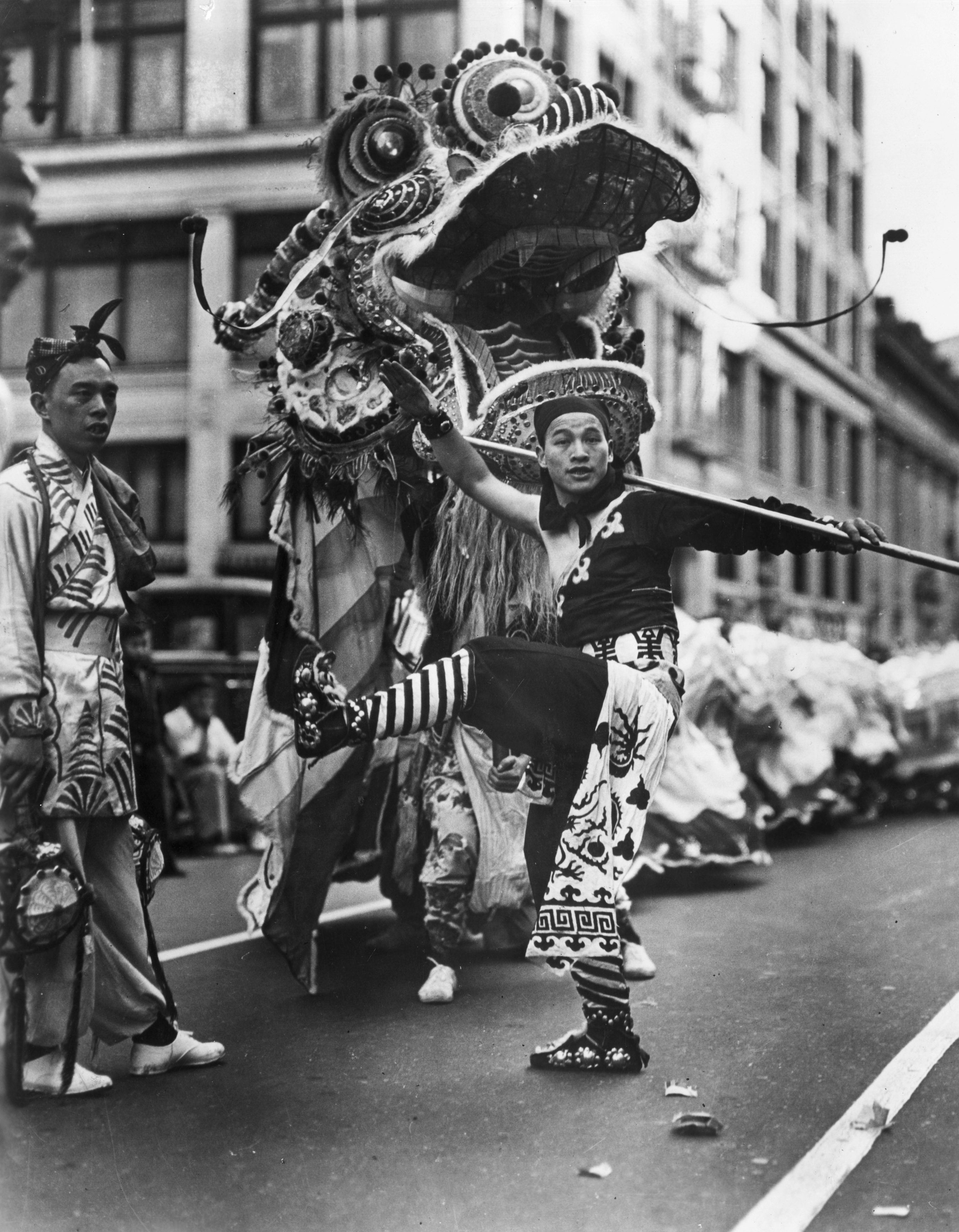 ***ONE TIME USE ONLY, PLEASE CLEAR THE COPYRIGHTS BEFORE RE-USE *** circa 1945: Performers and a dragon move through the street while celebrating Chinese New Year with the dragon dance in Chinatown, San Francisco, California. (CREDIT: Getty Images / Hulton Archive) [08FEBRUARY2016 FEATURES ONLINE]