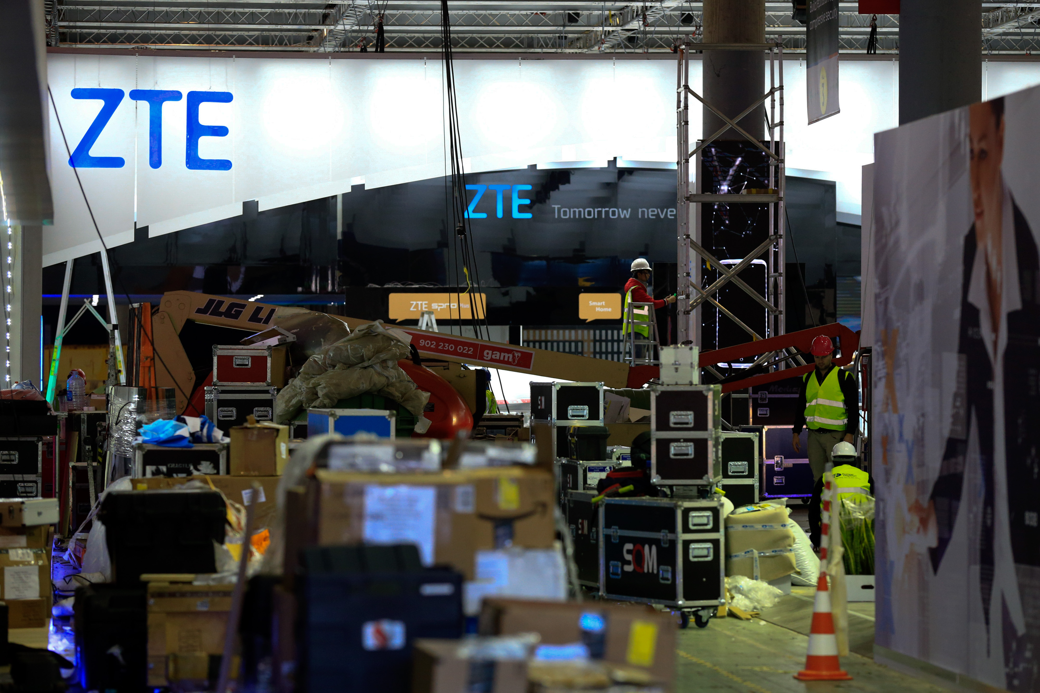 Workers make final preparations to ZTE’s stand at the Mobile World Congress in Barcelona on Saturday. Photo: Bloomberg