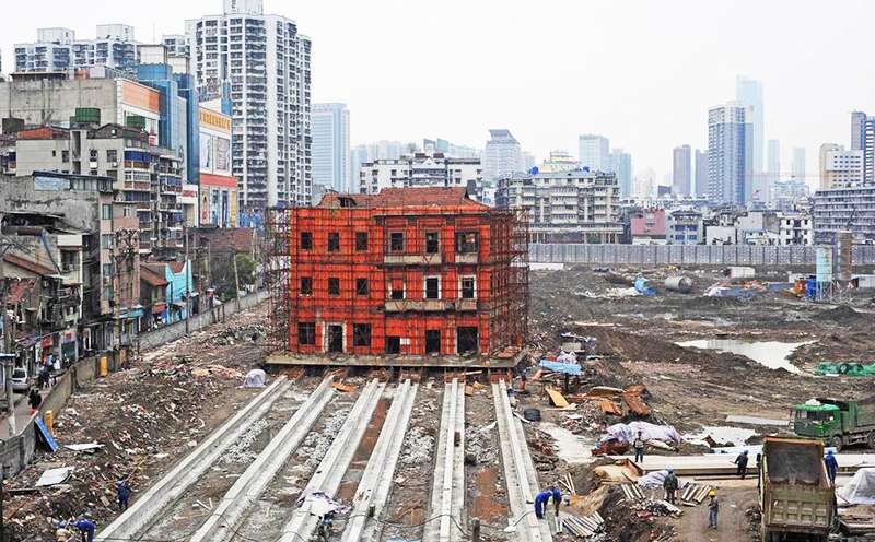 The historic building in the city of Wuhan has been lifte 1.4 metres off the ground onto a new base so it can be moved 90 metres on six concrete rails to make way for redevelopment of the site. Photo: Qq.com