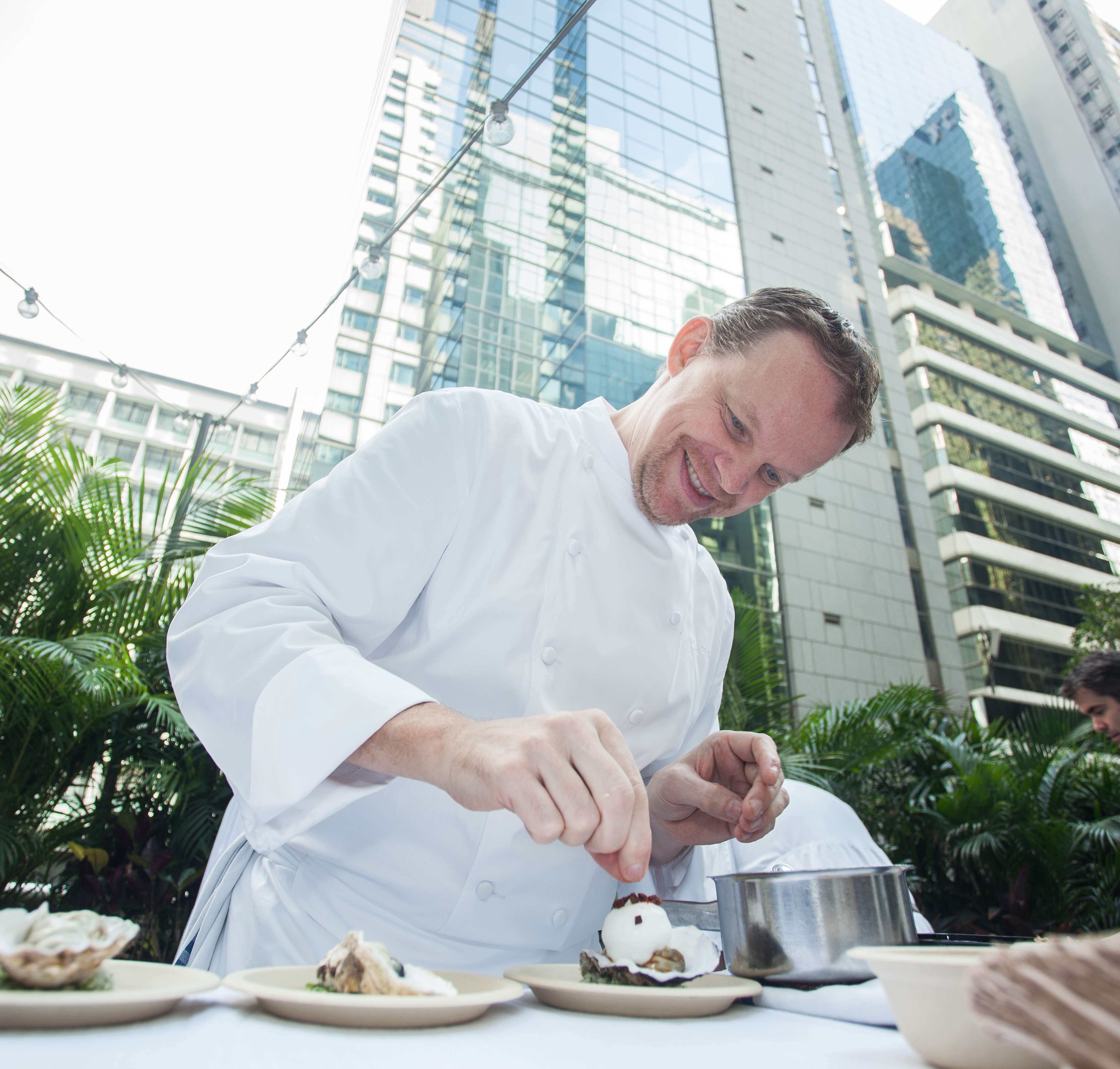 Chef Richard Ekkebus applies the finishing touches to a dish from Amber restaurant at Taste of Hong Kong.