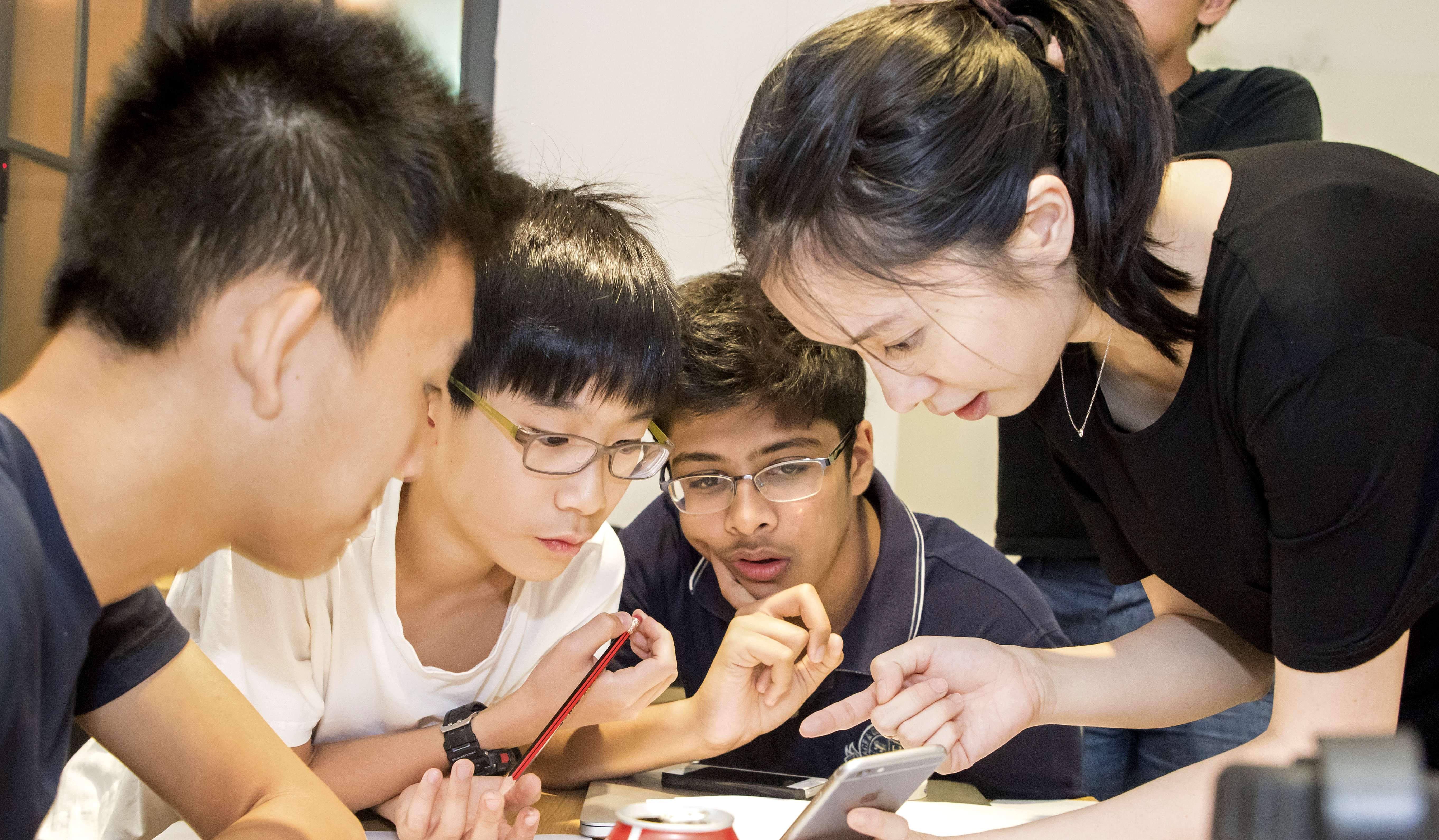 Michelle Sun (Right) Founder and CEO of First Code Academy teach students how to design an app at a programming school in Wan Chai. Photo: SCMP Pictures