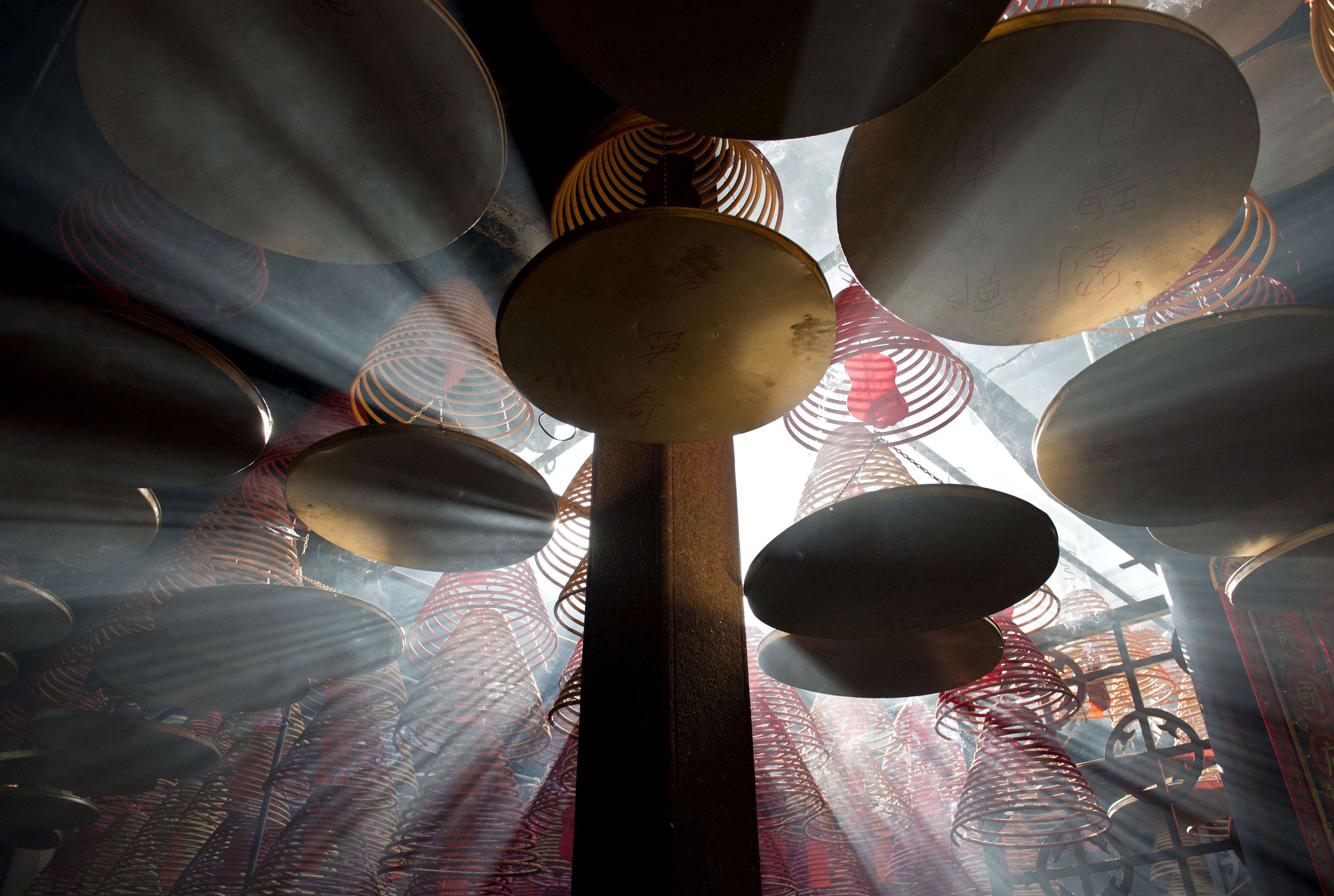 Sunlight shines through hanging incense coils at the Tin Hau Temple in Yau Ma Tei. Photo: AFP