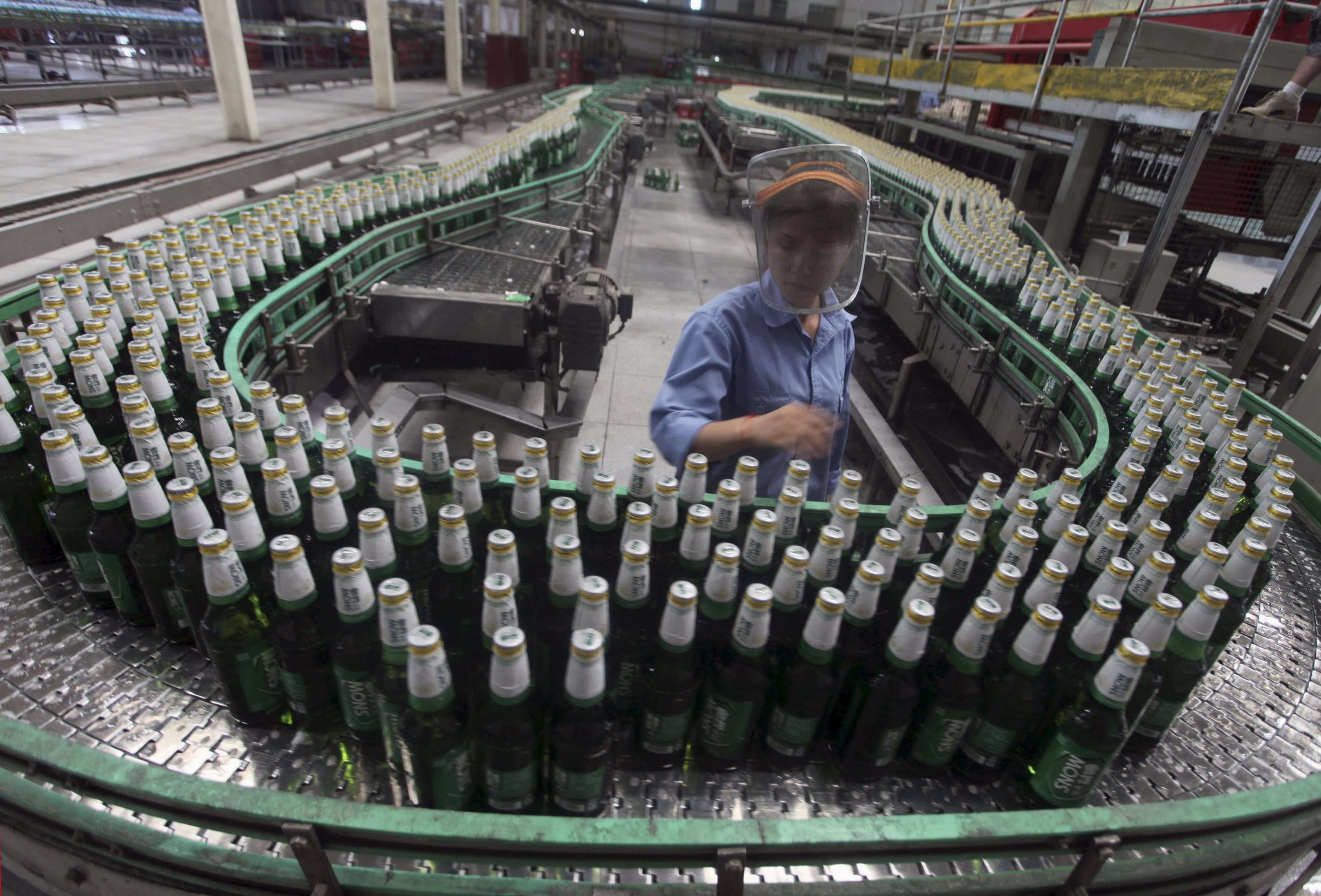 A labourer works at an assembly line in a factory of China Resources Snow Breweries in Lanzhou, Gansu province. Photo: Reuters