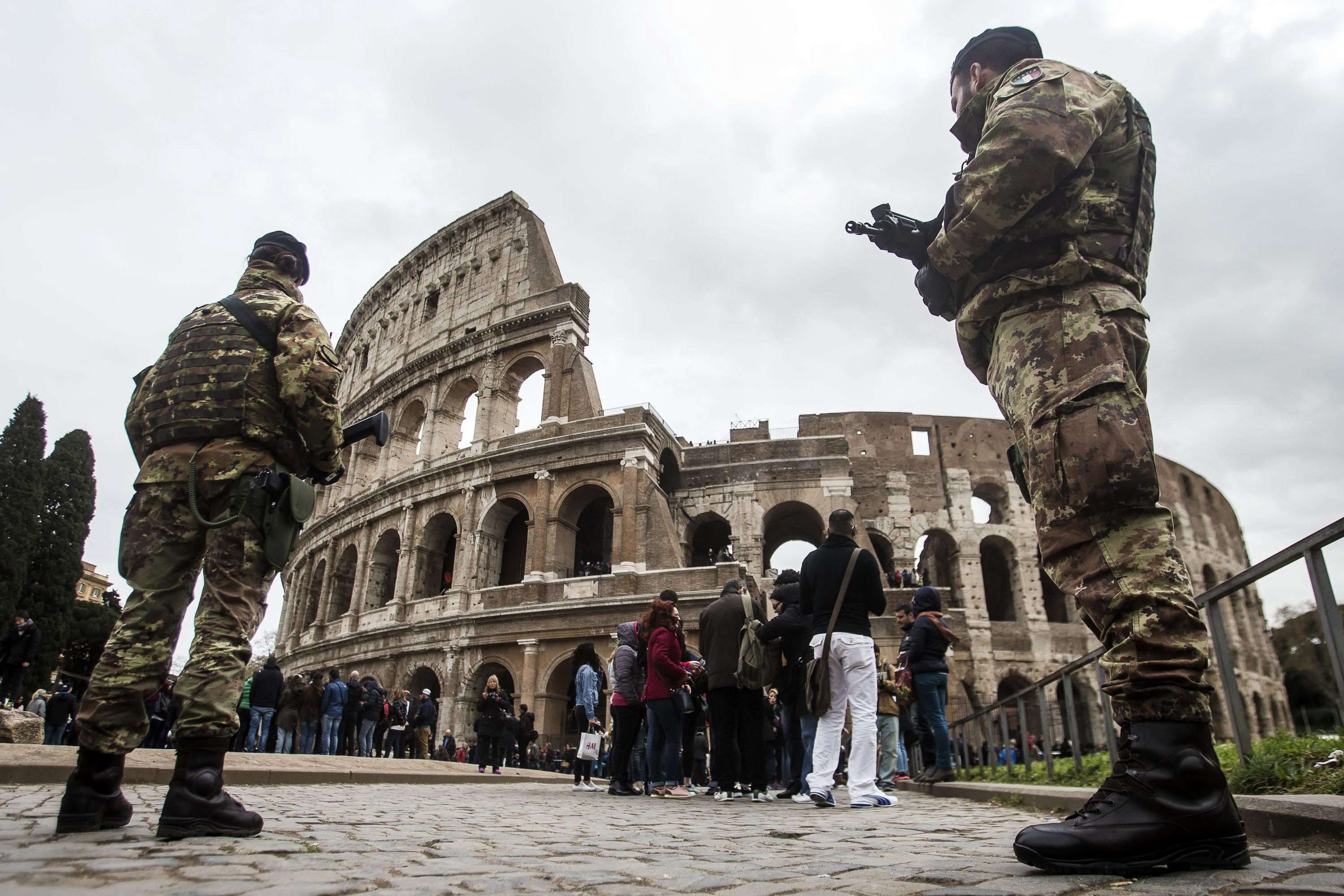 Soldiers guard the Colosseum in Rome on Wednesday amid heightened tension in the wake of the Brussels terrorist attacks. Photo: EPA