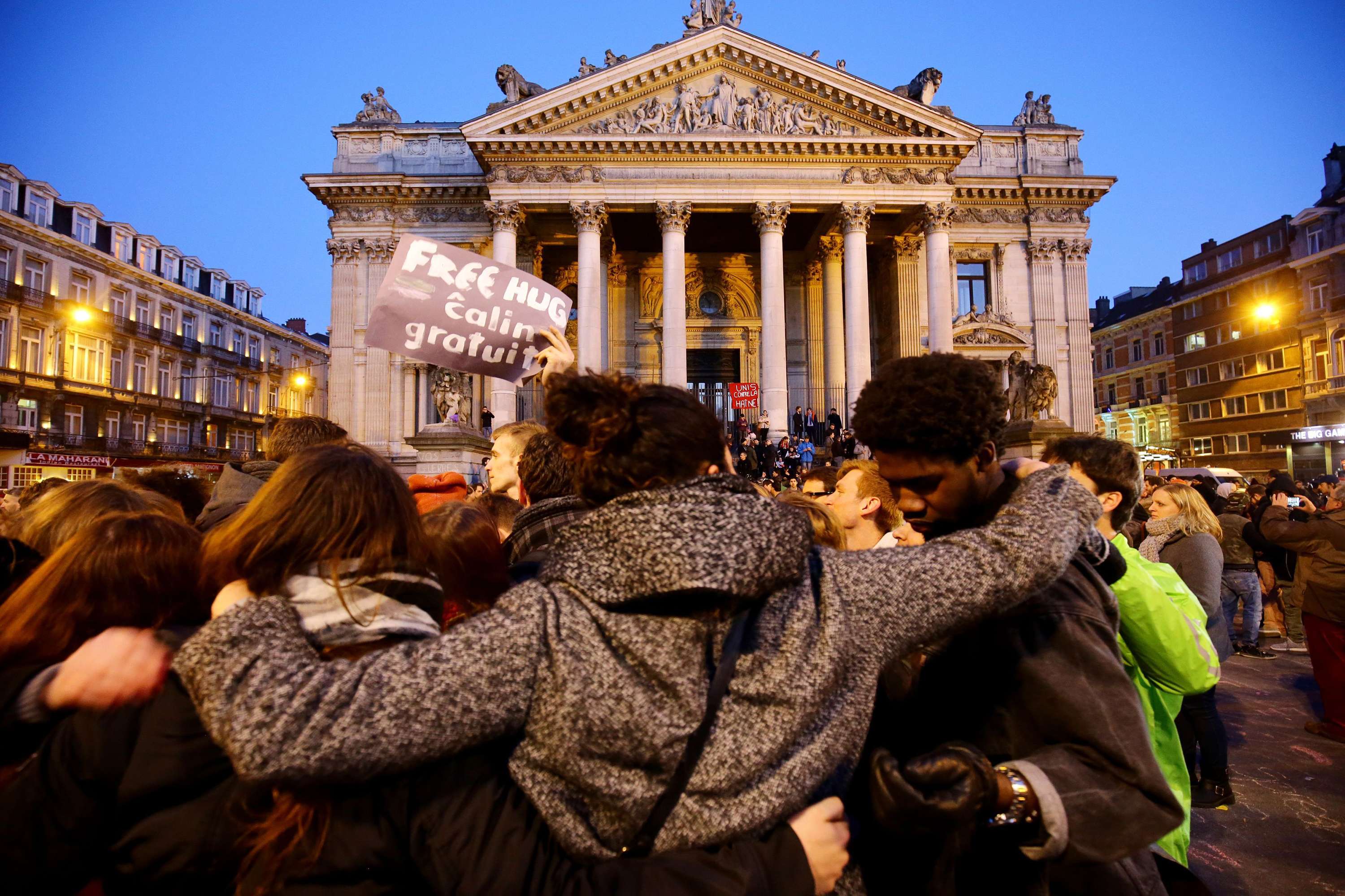 People gather at the Place de la Bourse in Brussels to leave messages and tributes following the terrorist attacks on March 22. Photo: PA Wire/Zuma Press/Tribune News Service