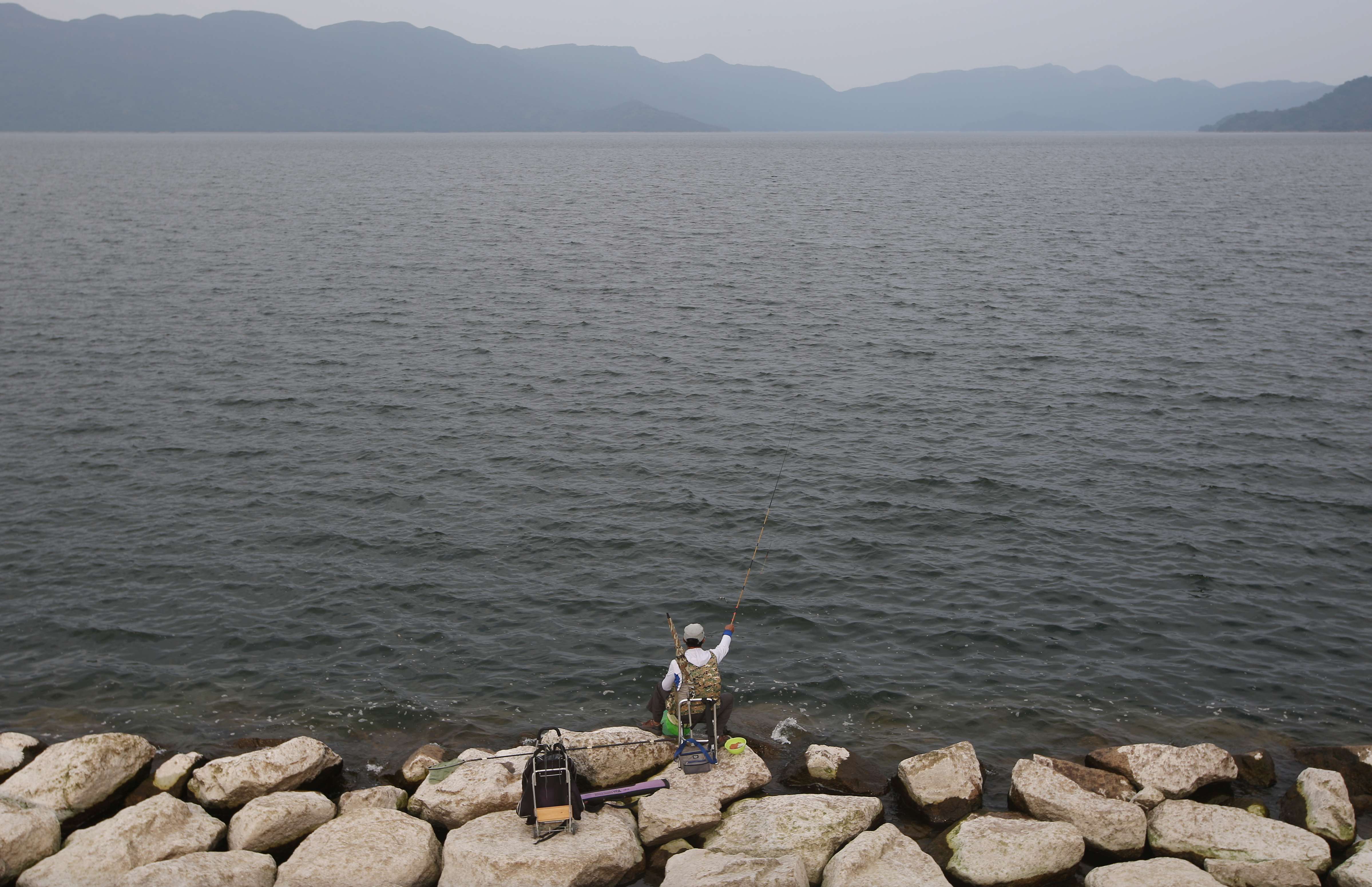 A man fishes at Plover Cove Reservoir in northeast Hong Kong. Photo: Sam Tsang