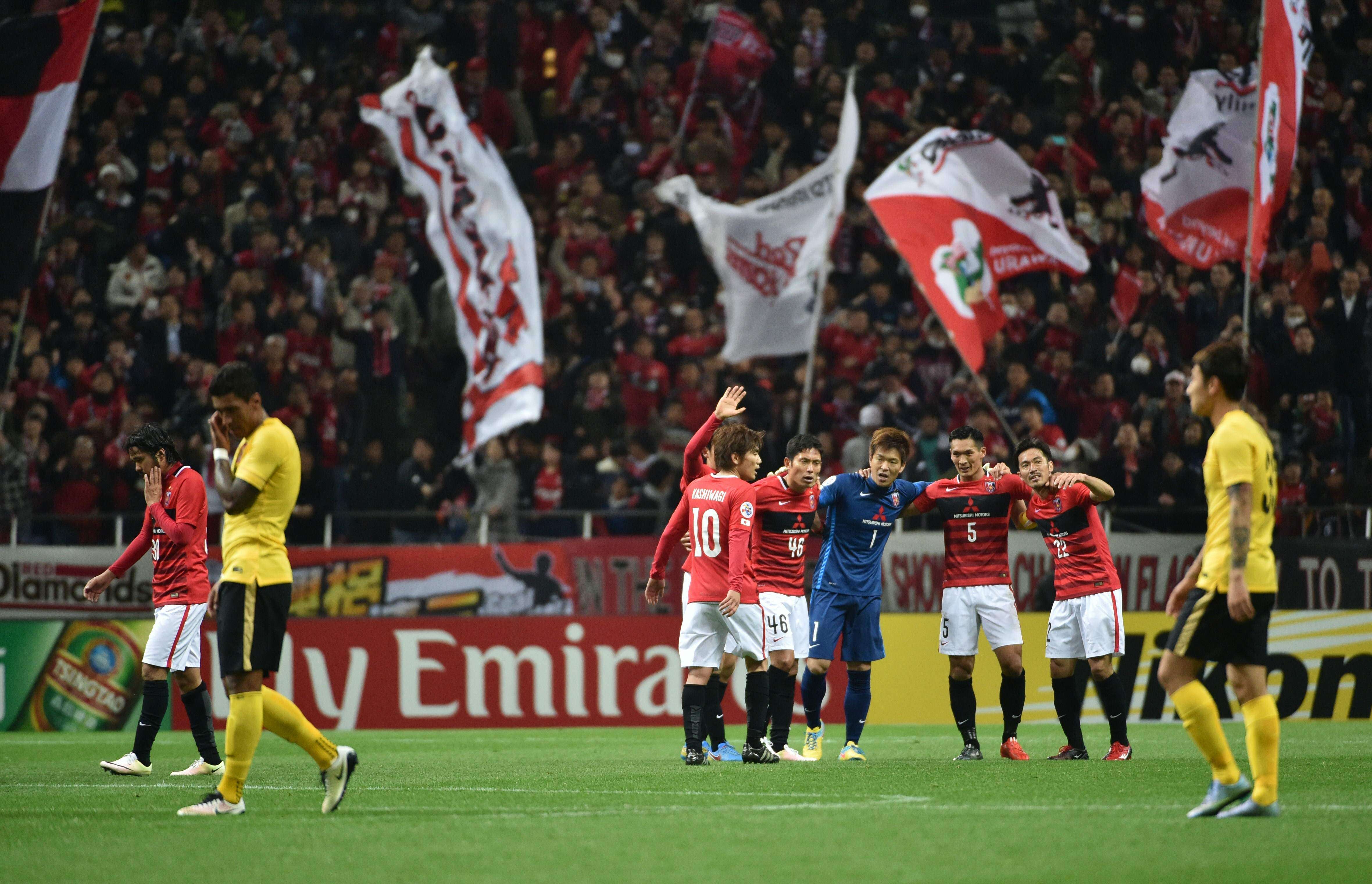 Urawa Reds players celebrate their victory over Guangzhou Evergrande in group H in Saitama. Photo: AP
