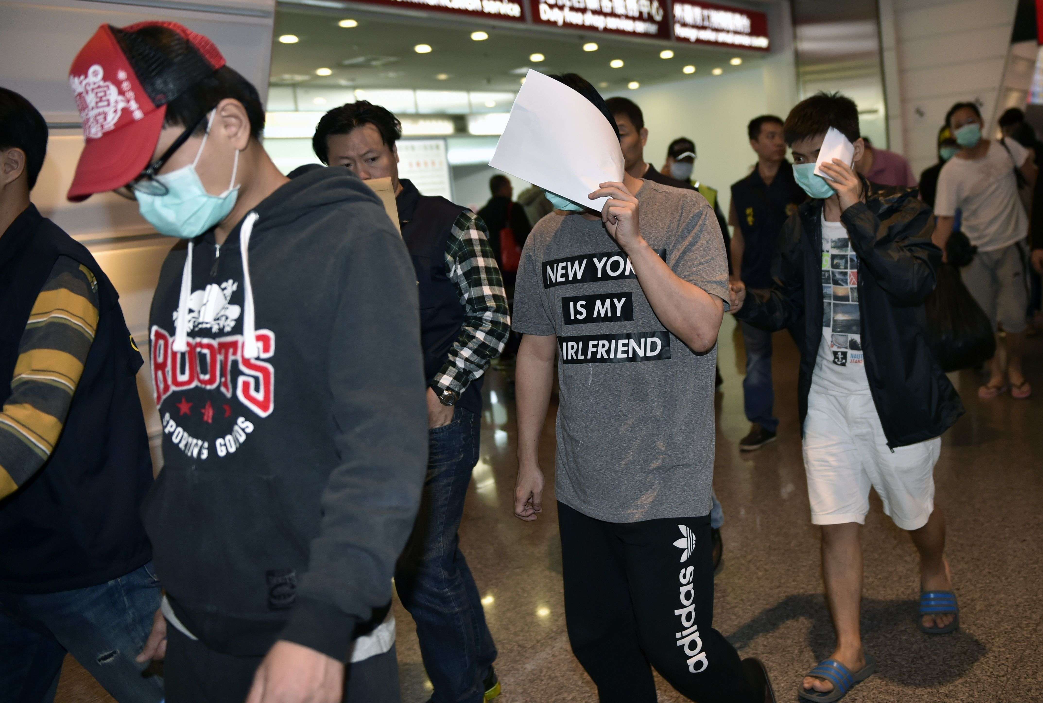 Taiwanese nationals arrive at Taoyuan International Airport in Taipei on Friday. Malaysia deported them back to Taiwan despite Beijing seeking to have them sent to the mainland. Photo: AFP