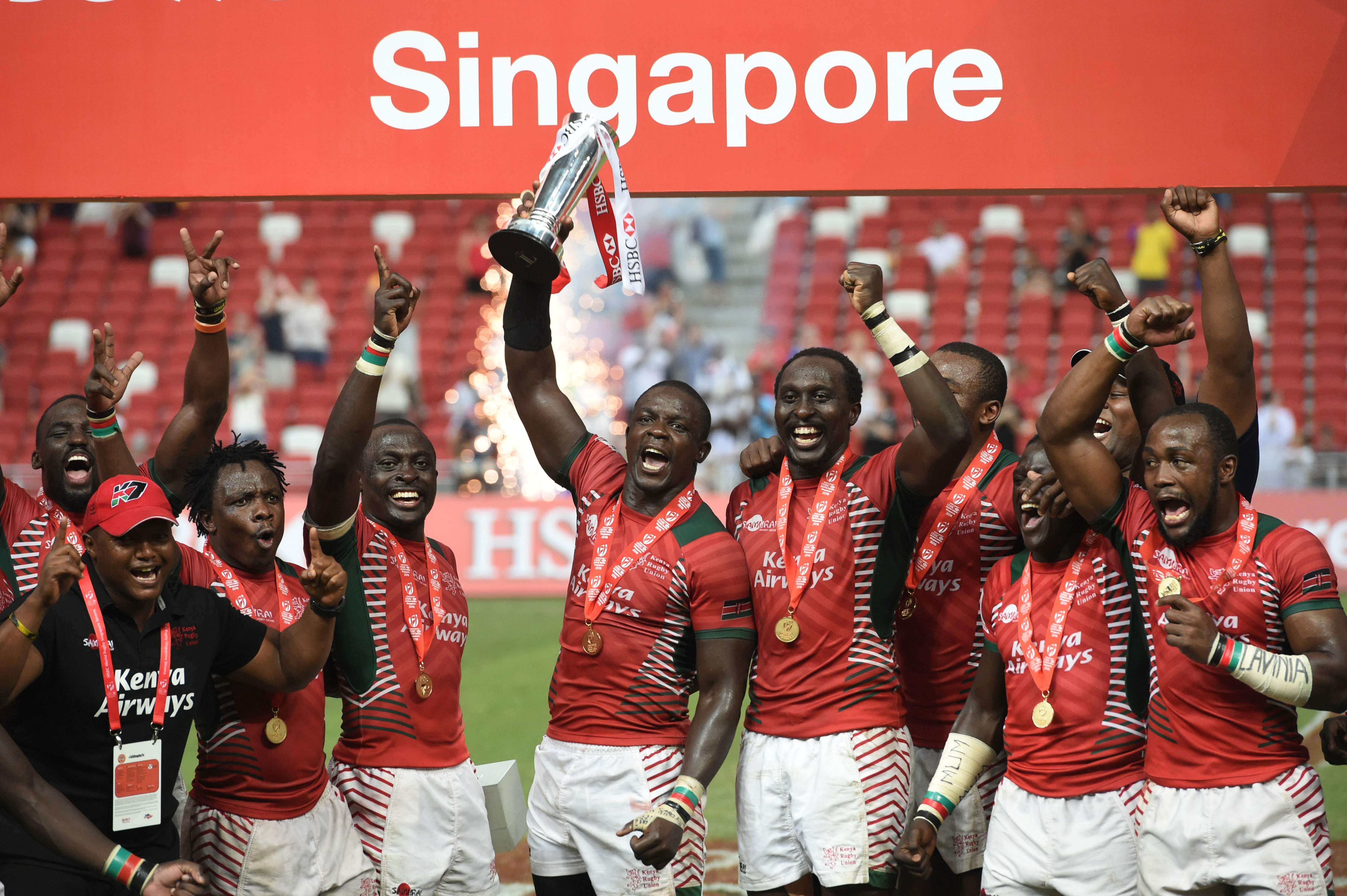 Kenya's team celebrate with the trophy after defeating Fiji in the cup final at the Singapore Sevens. Photo: AFP