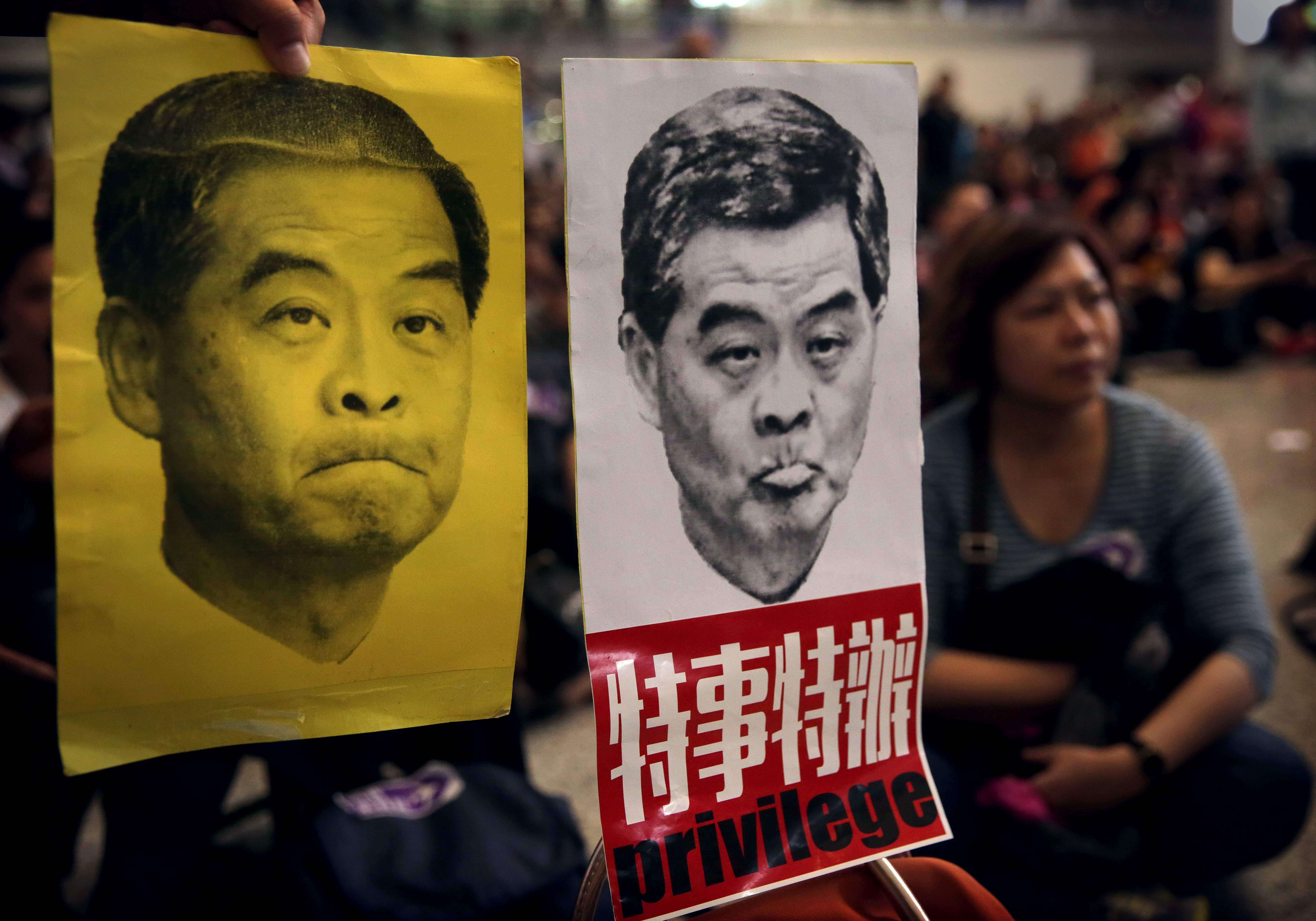 Protesters hold up pictures of Chief Executive Leung Chun-ying during a protest at Hong Kong International Airport last Sunday. Photo: AFP