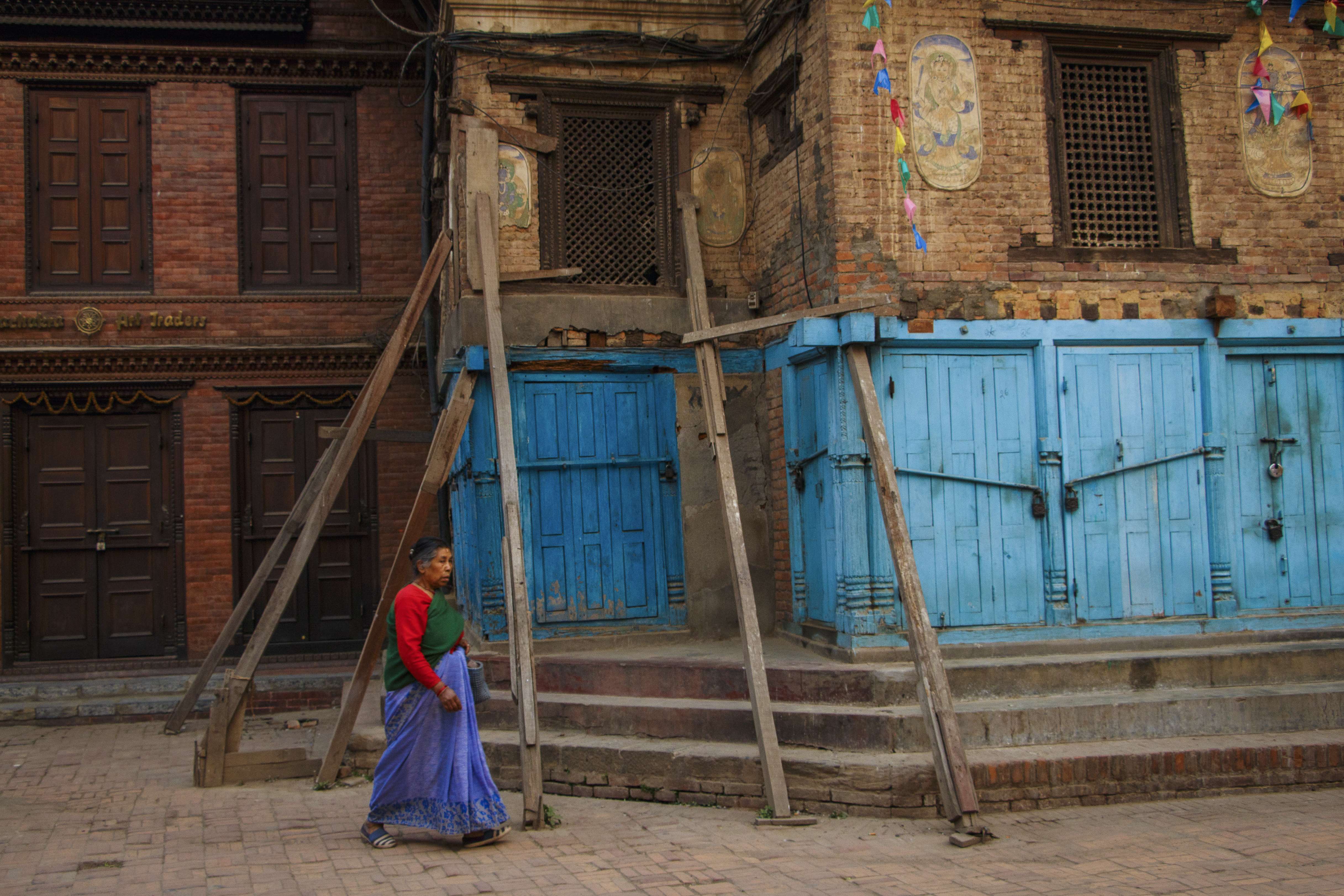 A woman wearing traditional dress walking through the back streets behind Patan Durbar Square. Photo: Tessa Chan