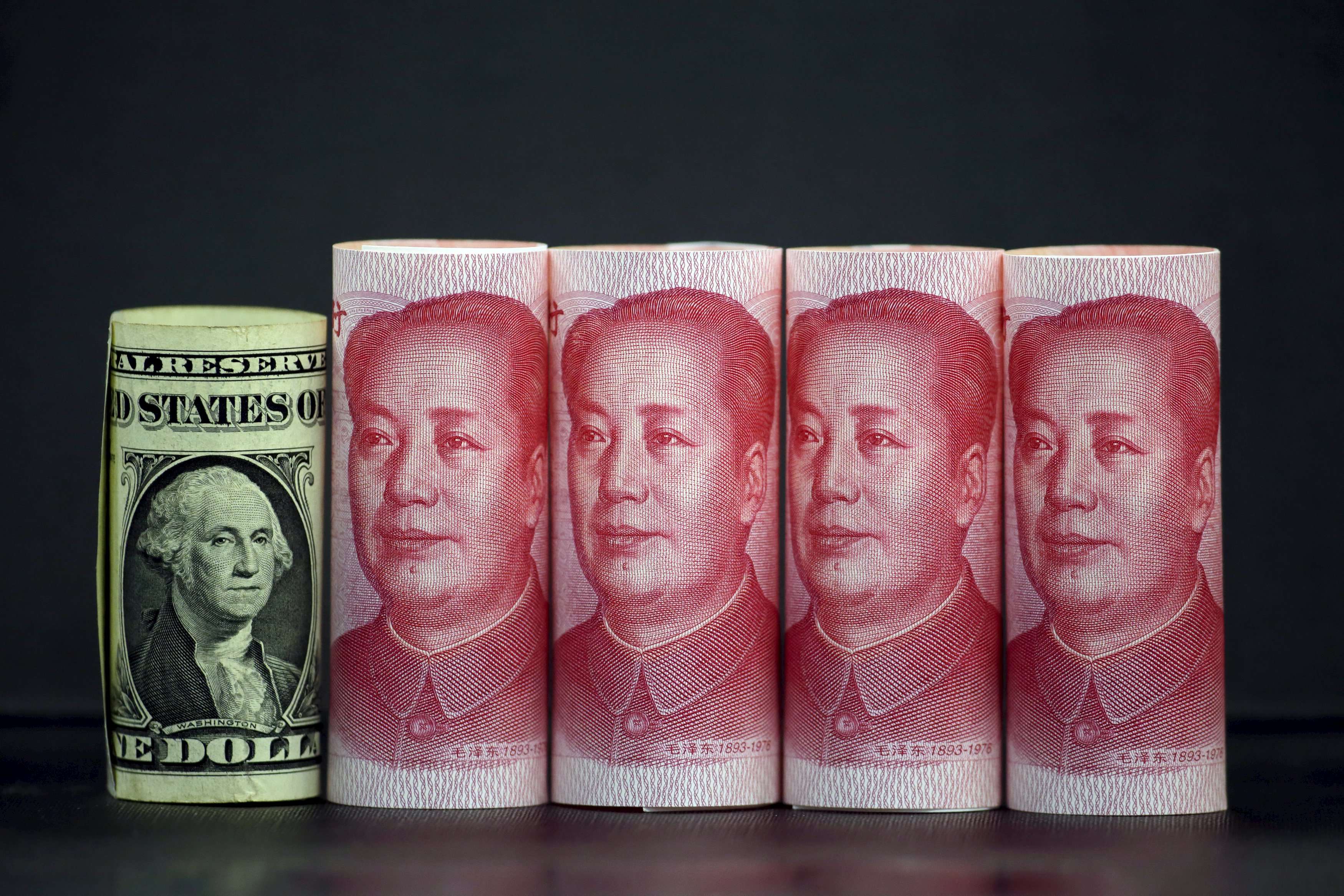 Chinese 100 yuan banknotes and a U.S. one dollar banknote. Photo: Reuters, Jason Lee