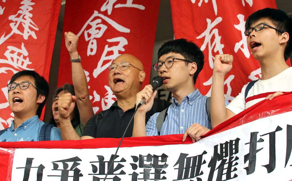Raphael Wong (far left), Leung Kwok-hung, Albert Chan, Nathan Law and Joshua Wong protest outside court. Photo: Felix Wong
