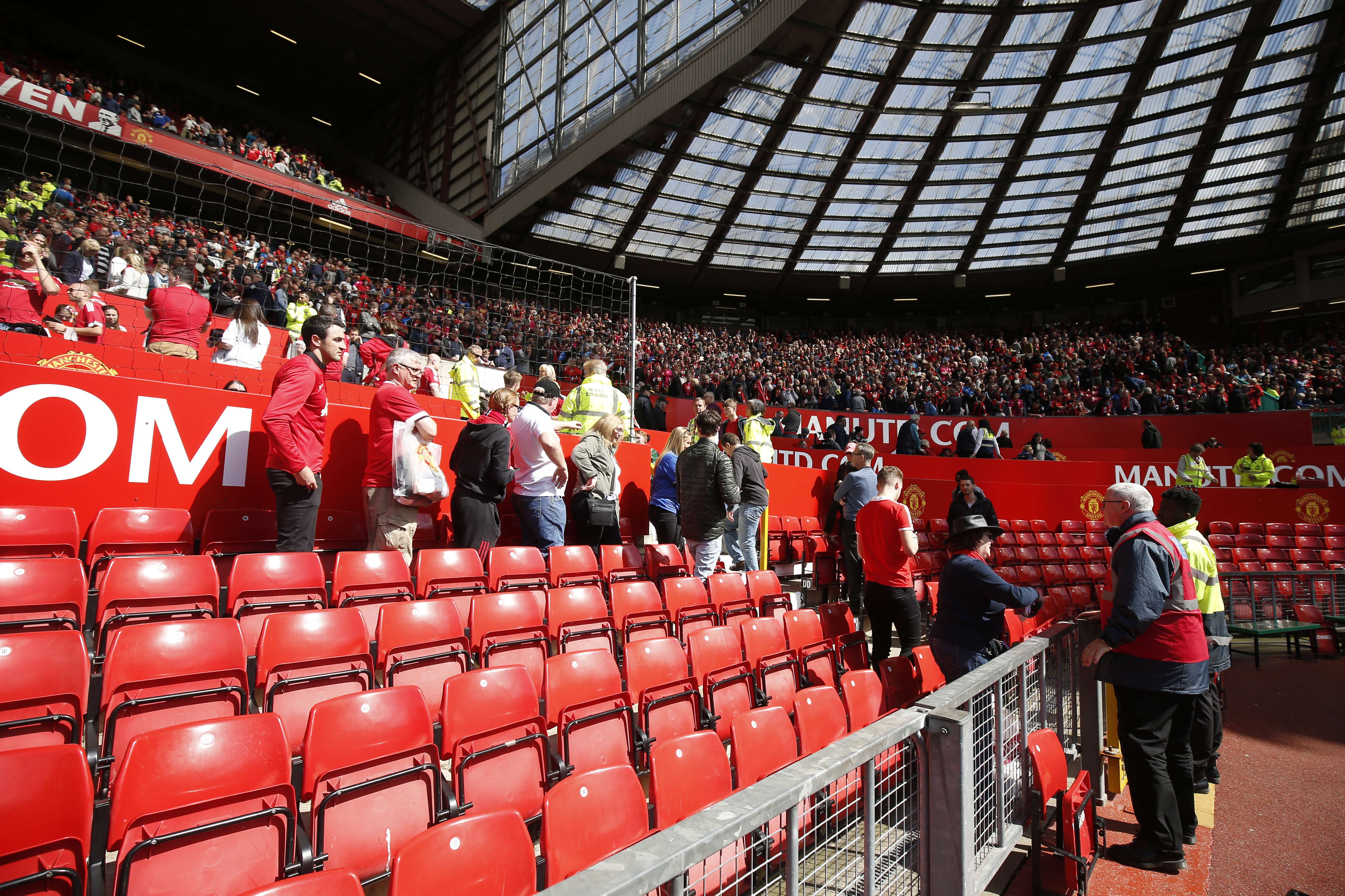 Football fans at Old Trafford evacuate the ground after the discovery of a suspect device. Photo: Reuters