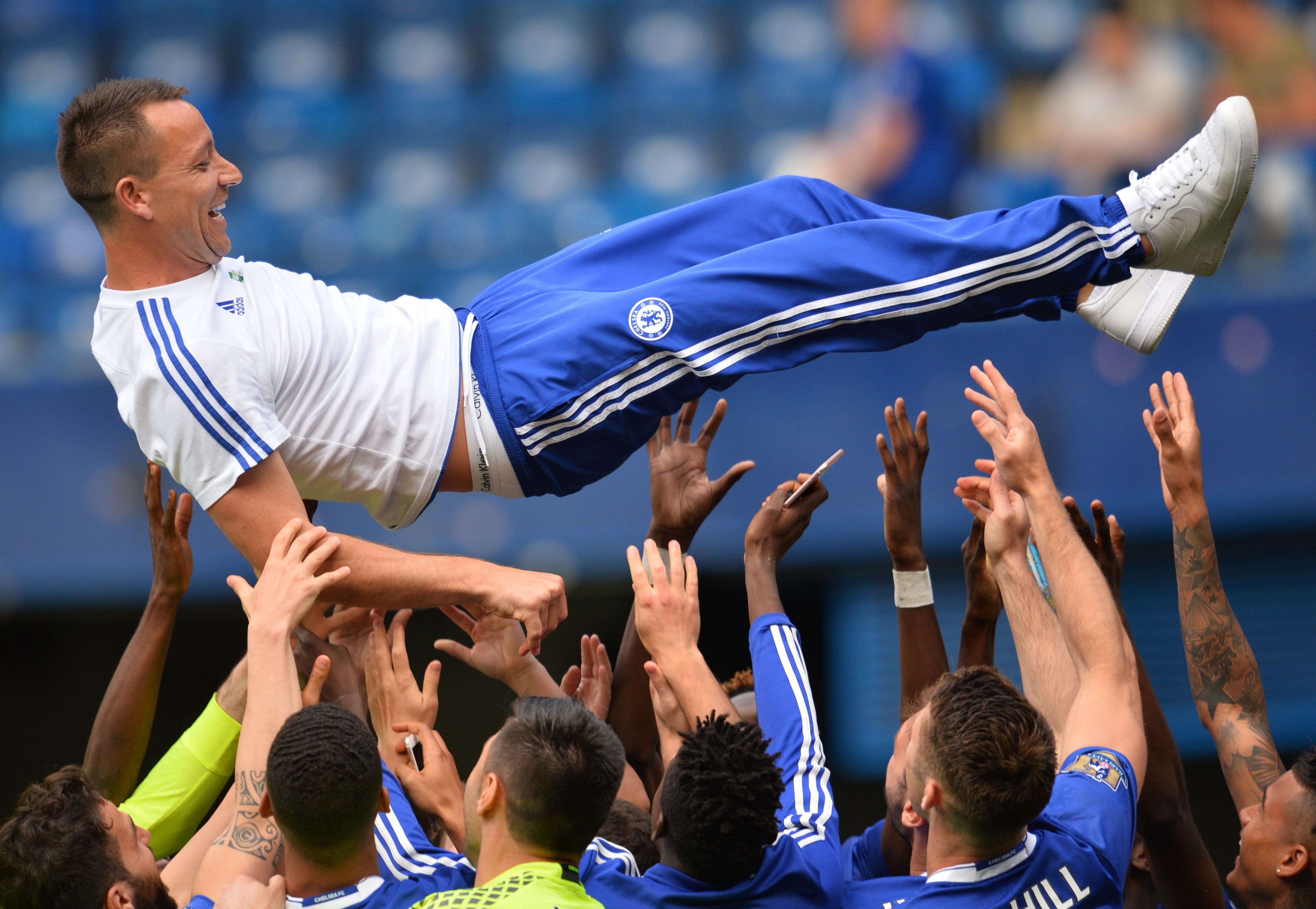 Chelsea captain John Terry is thrown in the air by teammates after the 1-1 draw with new champions Leicester City at Stamford Bridge. Terry, suspended for the game, said: “I want to stay. The club knows that, the fans know that.” Photo: AFP