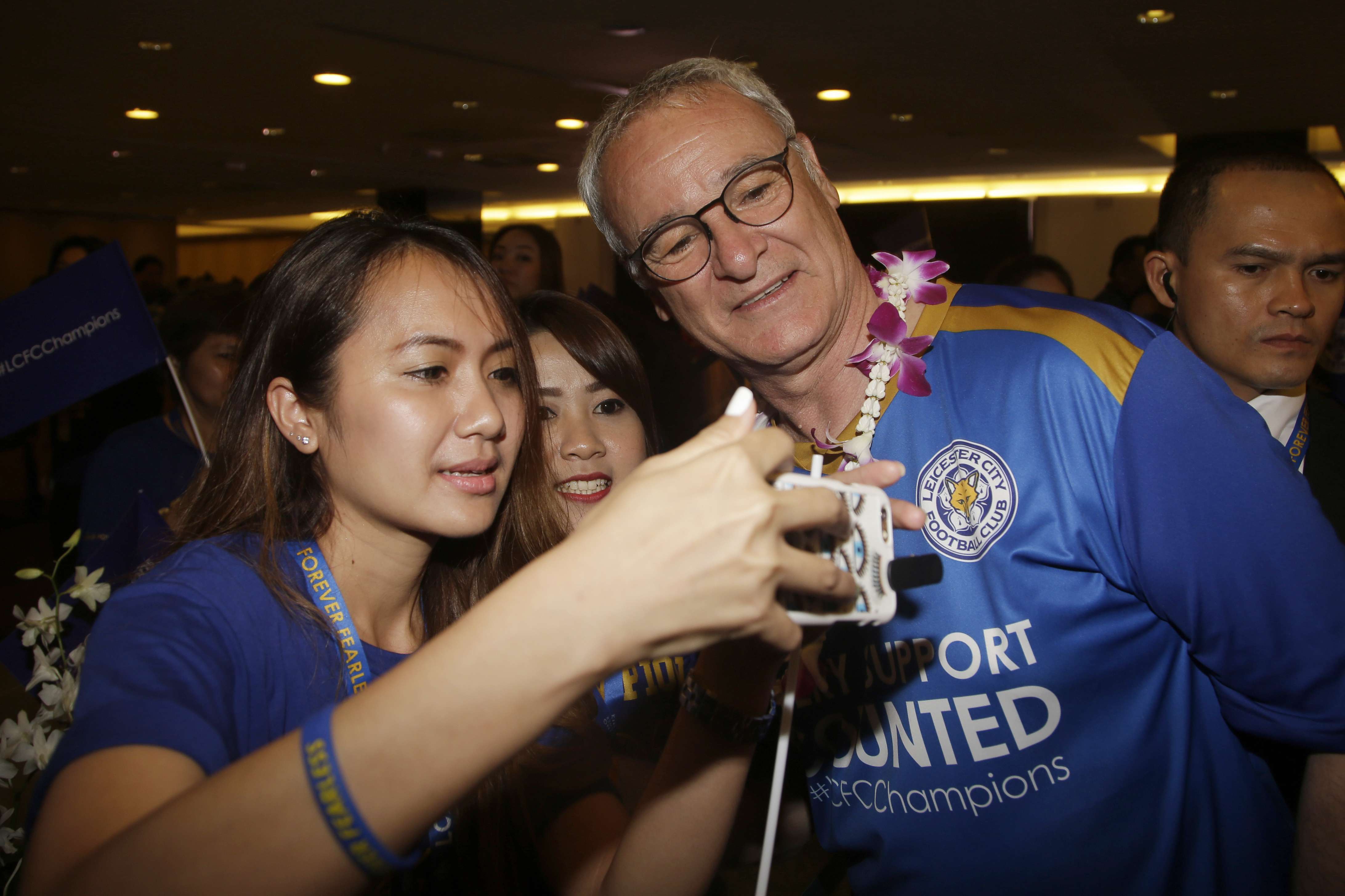 Who would not want a selfie with Leicester City manager Claudio Ranieri? A Thai soccer fan gets a priceless memento as the team arrived in Bangkok on Wednesday. Photo: AP