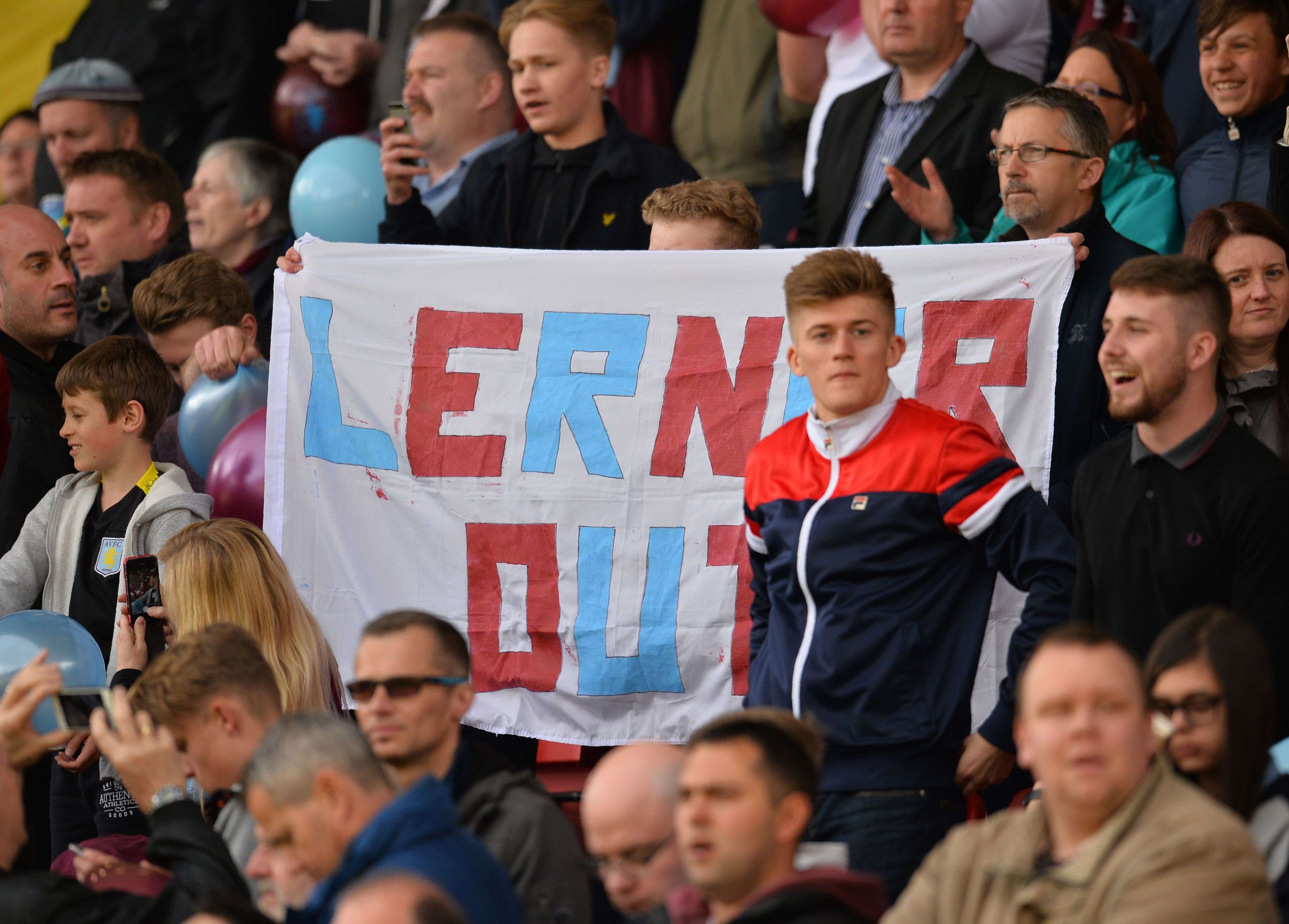 Aston Villa fans hold up a banner calling for the departure of then chairman Randy Lerner. Photo: AFP