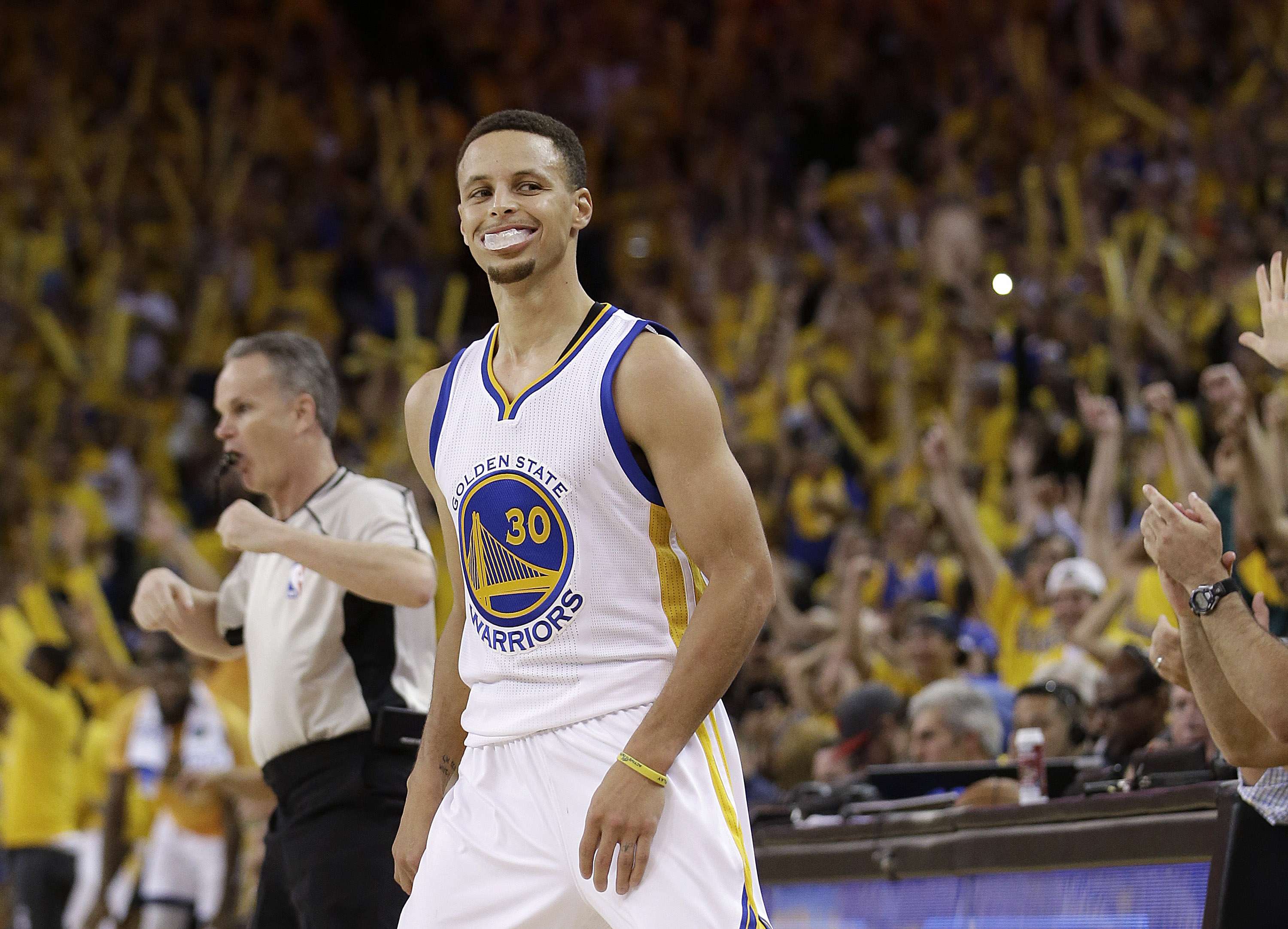 Golden State Warriors guard Stephen Curry smiles after scoring against the Oklahoma City Thunder. Photo: AP