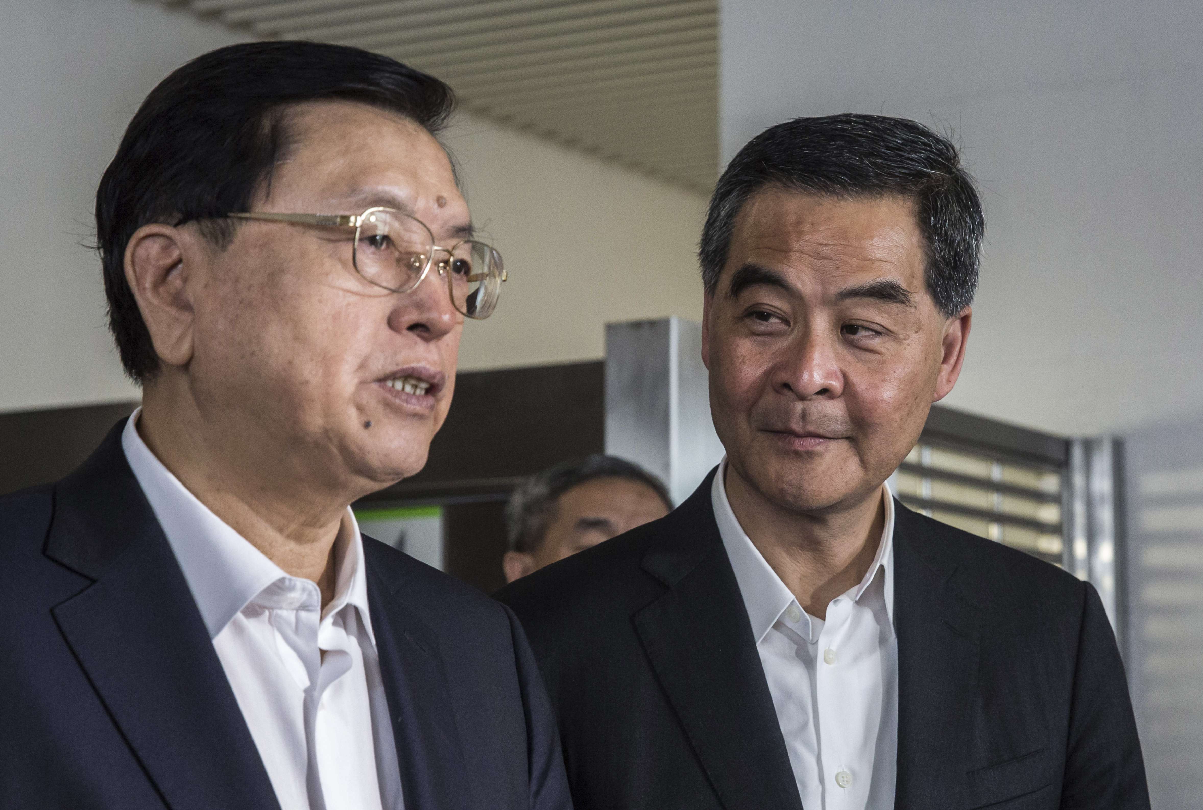 Hong Kong Chief Executive Leung Chun-ying, right, listens as Zhang Dejiang, chairman of China's National People's Congress speaks as they visit the foyer of a newly built public housing block due to open later this year in Hong Kong. Photo: SCMP Pictures