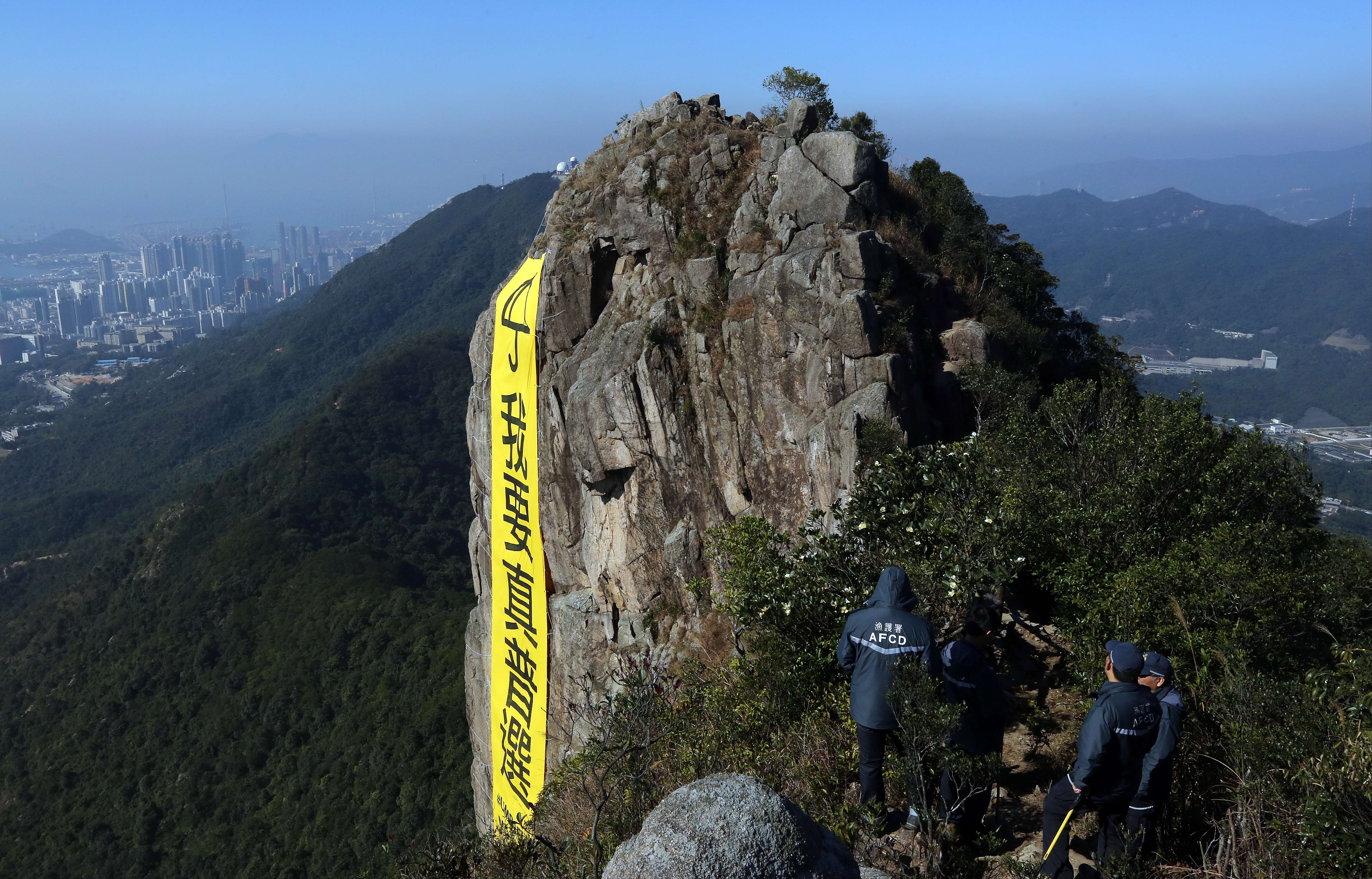 A pro-democracy banner saying “I want genuine universal suffrage” hangs on the Lion Rock, two weeks after the Occupy Central protests ended in December 2014. Photo: Felix Wong