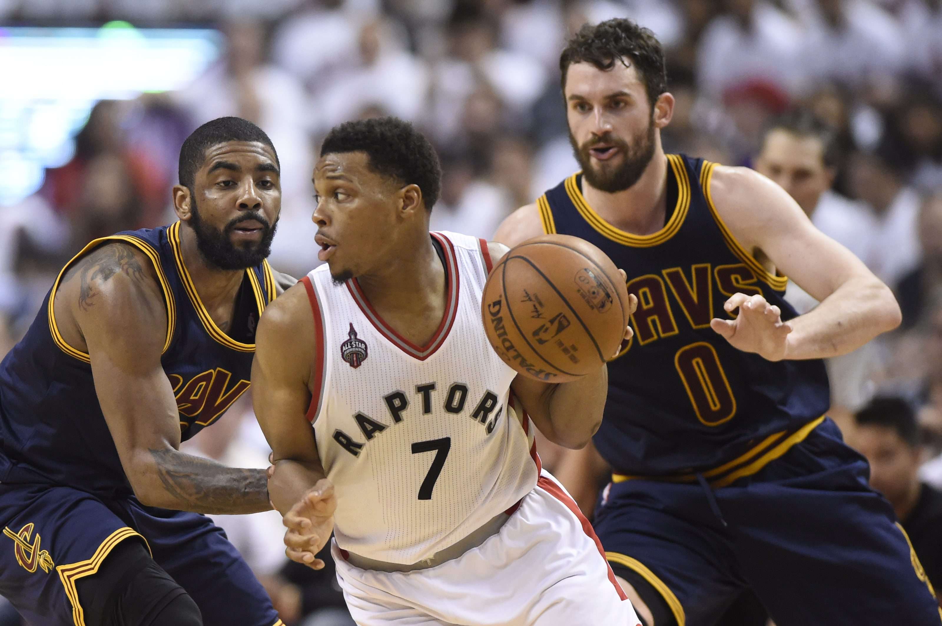 Kyle Lowry controls the ball as Kevin Love (0) and Kyrie Irving defend. Photo: AP
