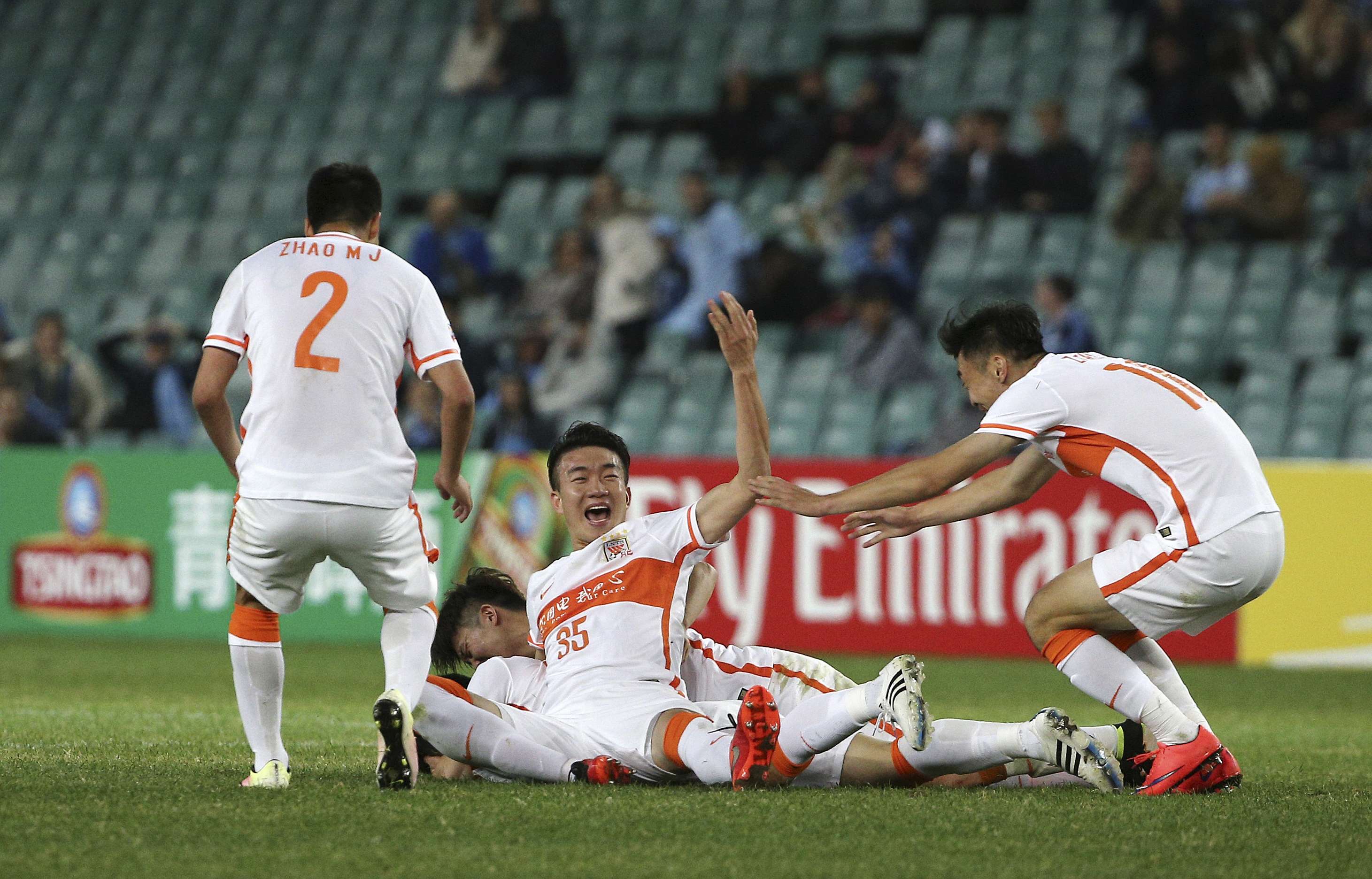 Shandong Luneng’s Dai Lin (centre) celebrates with teammates after scoring against Sydney FC during their AFC Champions League match in Sydney. Photo: AP