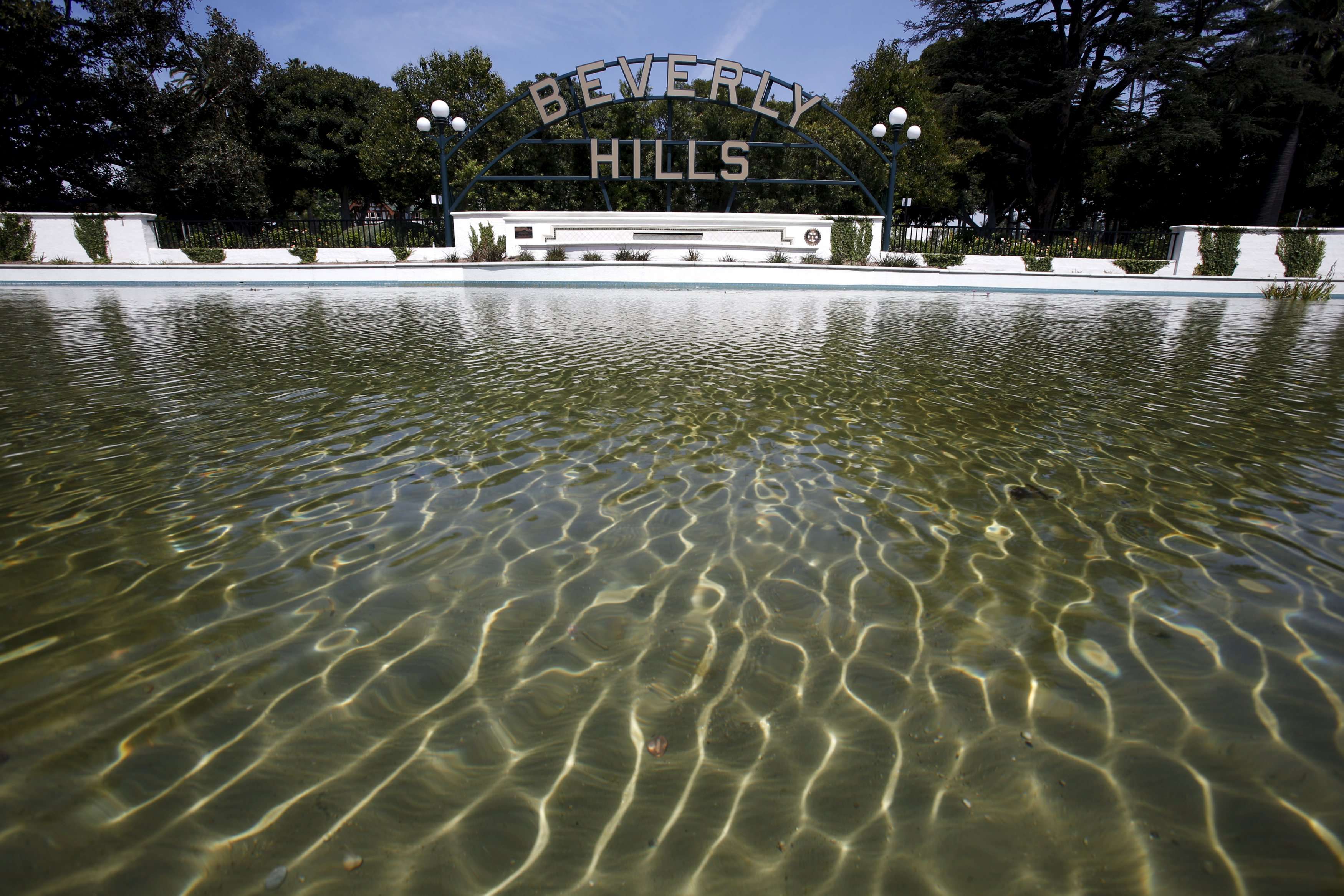 Water is seen in a pond in front of Beverly Hills' city sign, California, Photo; Reuters, Lucy Nicholson