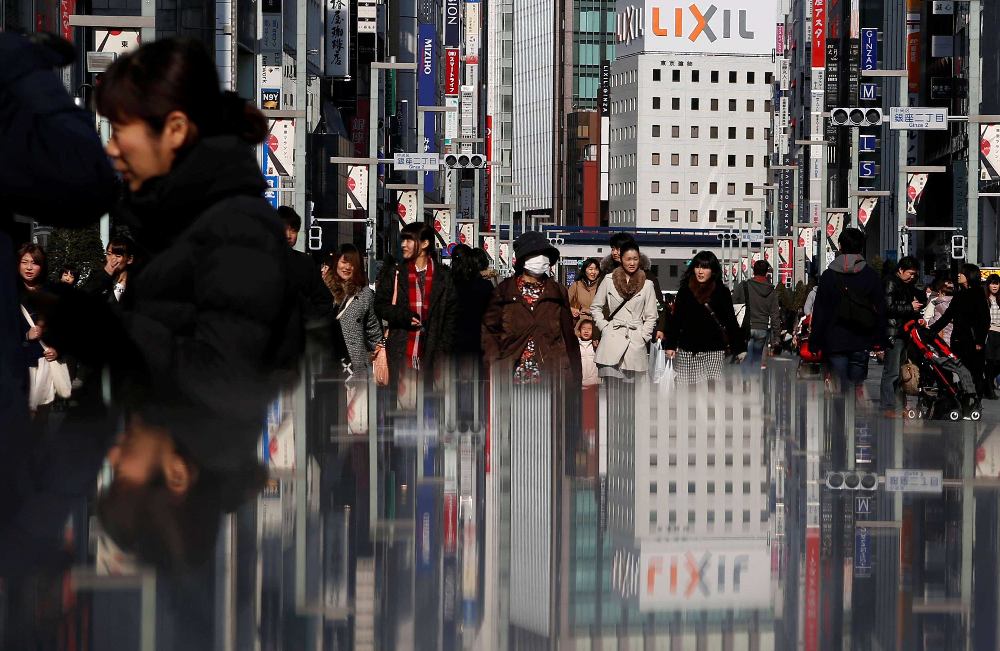 People walk on a street at Tokyo's Ginza shopping district. Photo: Reuters