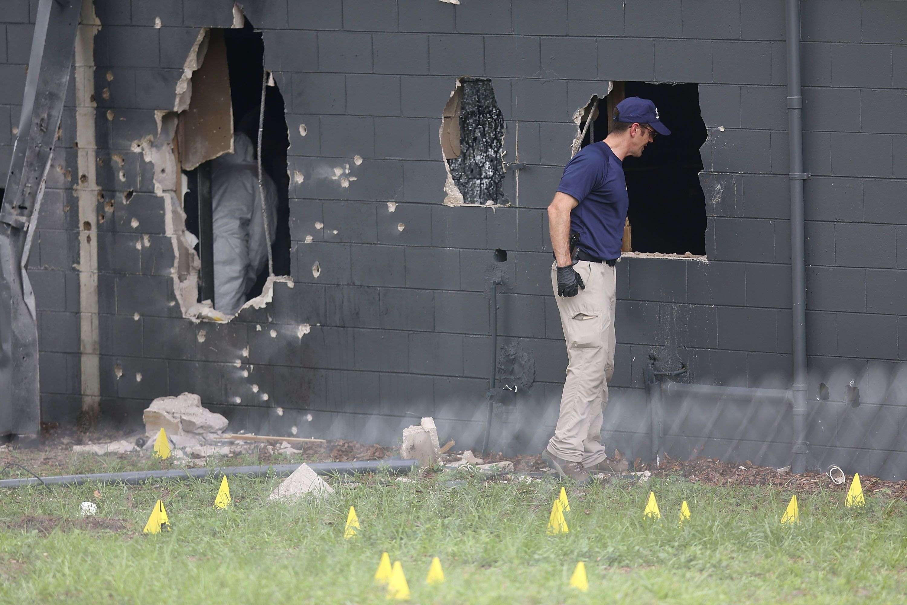 Bullet marks surround the hole in the rear wall of the Pulse nightclub through which dozens of clubgoers escaped. When gunman Omar Mateen emerged through the same hole, 14 officers opened fire on him. Photo: AFP