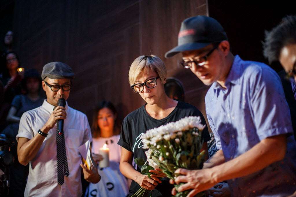 Denise Ho Wan-sze (centre) laying flowers at a vigil in Hong Kong on Monday for shooting victims in Orlando, Florida. Photo: AFP